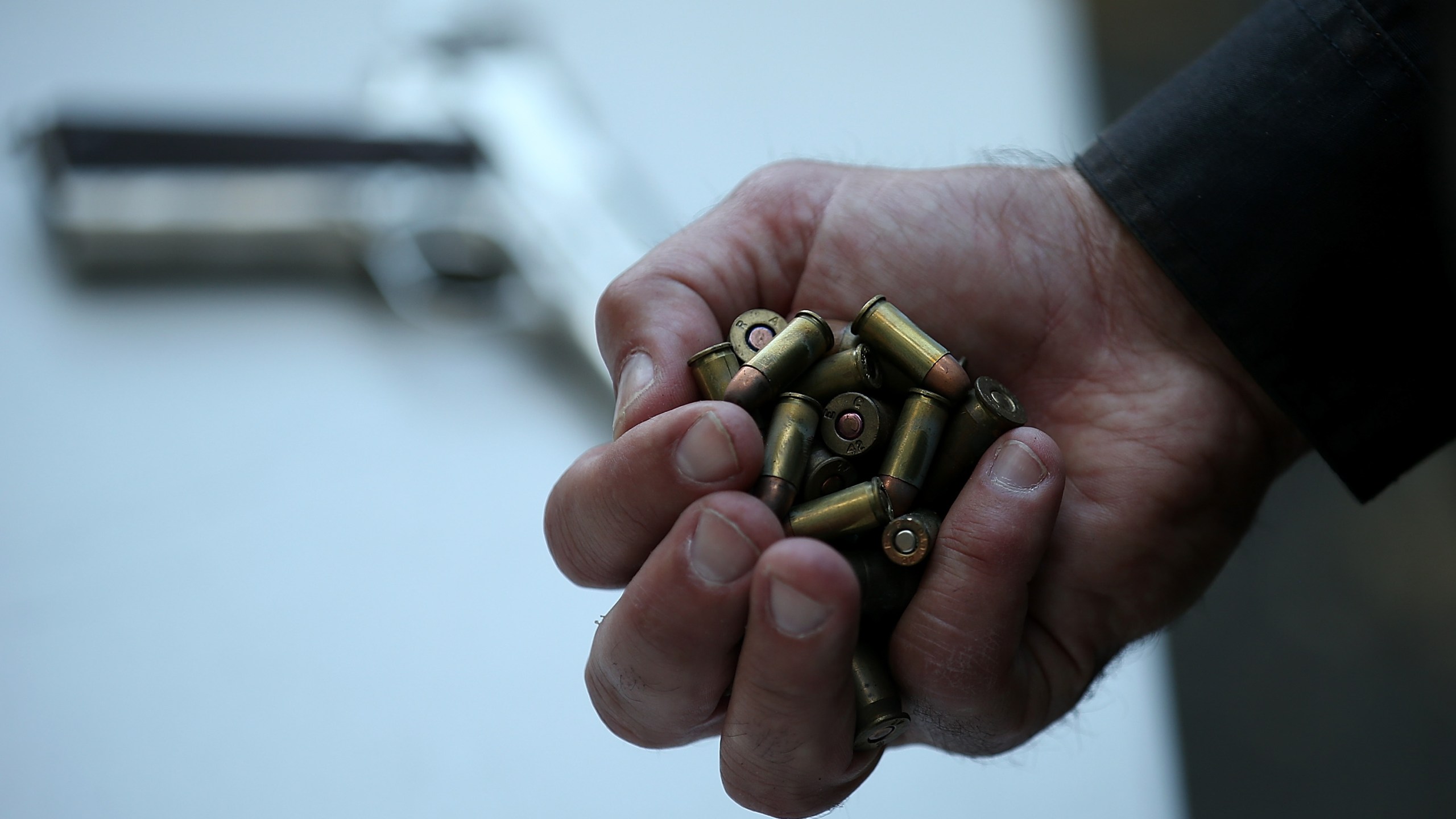 A San Francisco police officer holds a handful of ammunition that was surrendered during a gun buyback event in San Francisco on Aug, 8, 2013. (Justin Sullivan / Getty Images)