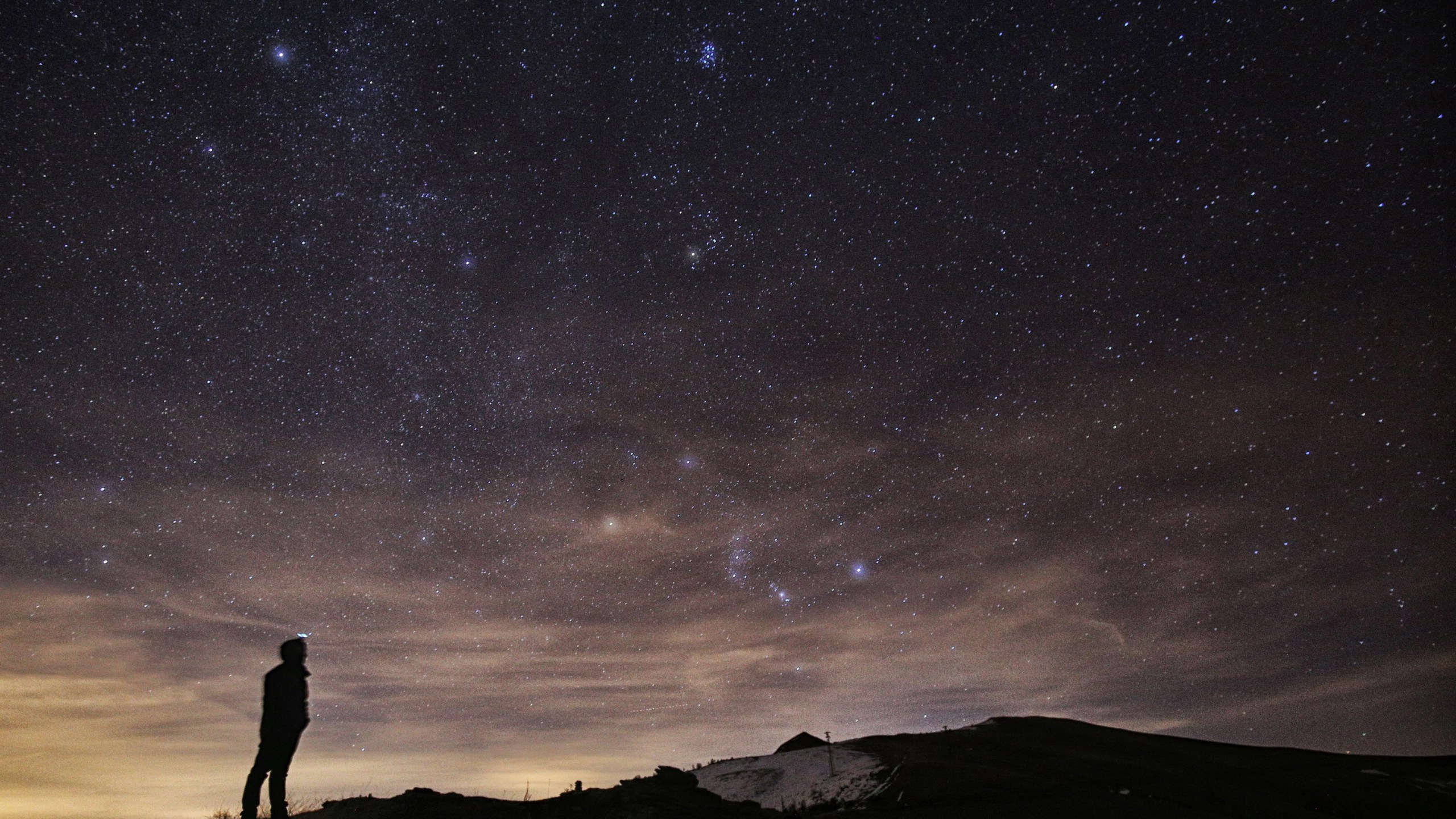 A photographer looks at the sky at night to see the annual Geminid meteor shower on the Elva Hill in northern Italy, Dec. 12, 2015. (Credit: Marco Bertorello / AFP / Getty Images)