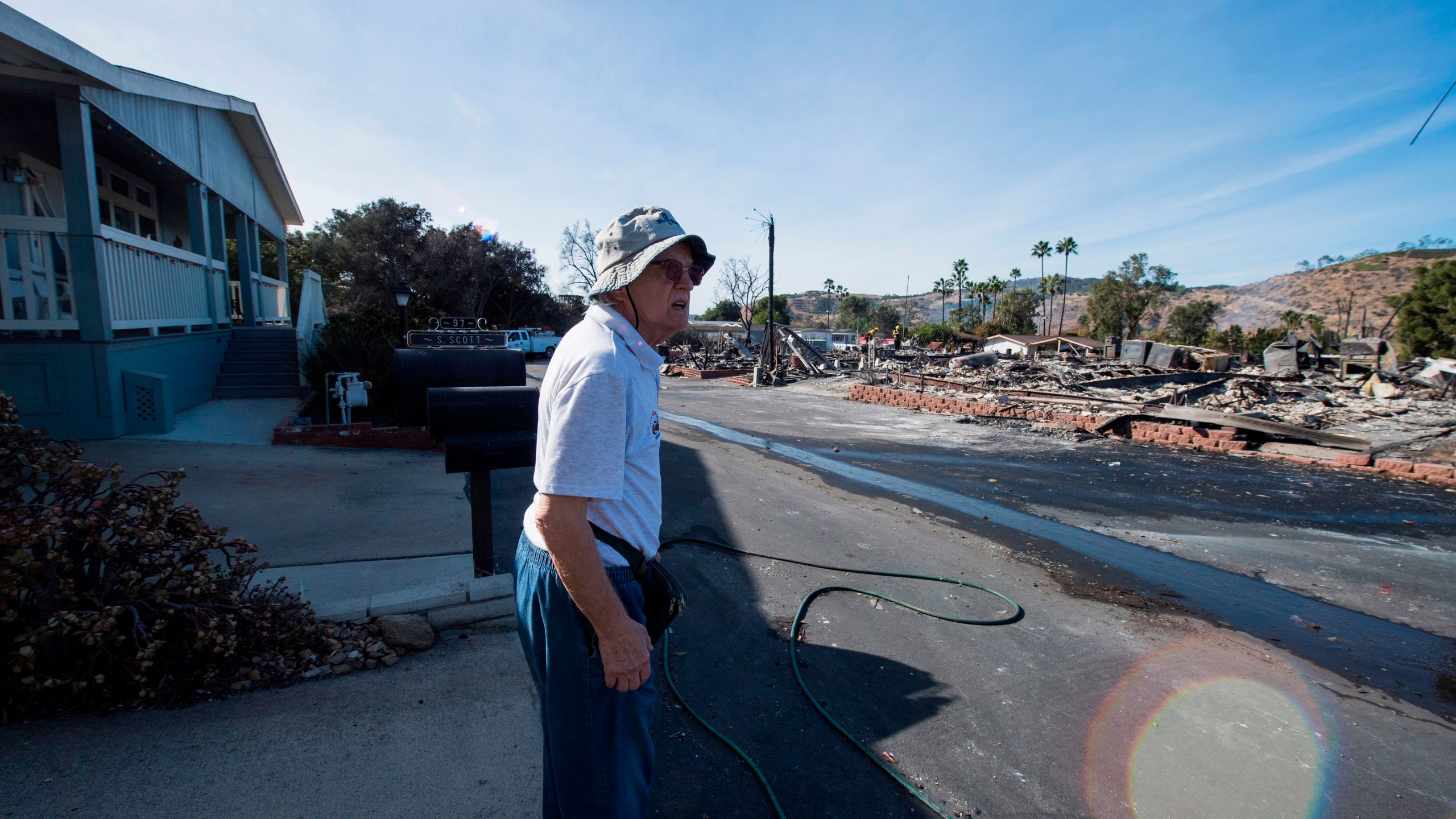 Local resident Pal Paricsy looks over the remains of his neighbors' homes destroyed by the Lilac Fire, Dec. 8, 2017, at a retirement community in Fallbrook, in San Diego County. (Credit: AFP PHOTO / Robyn Beck)