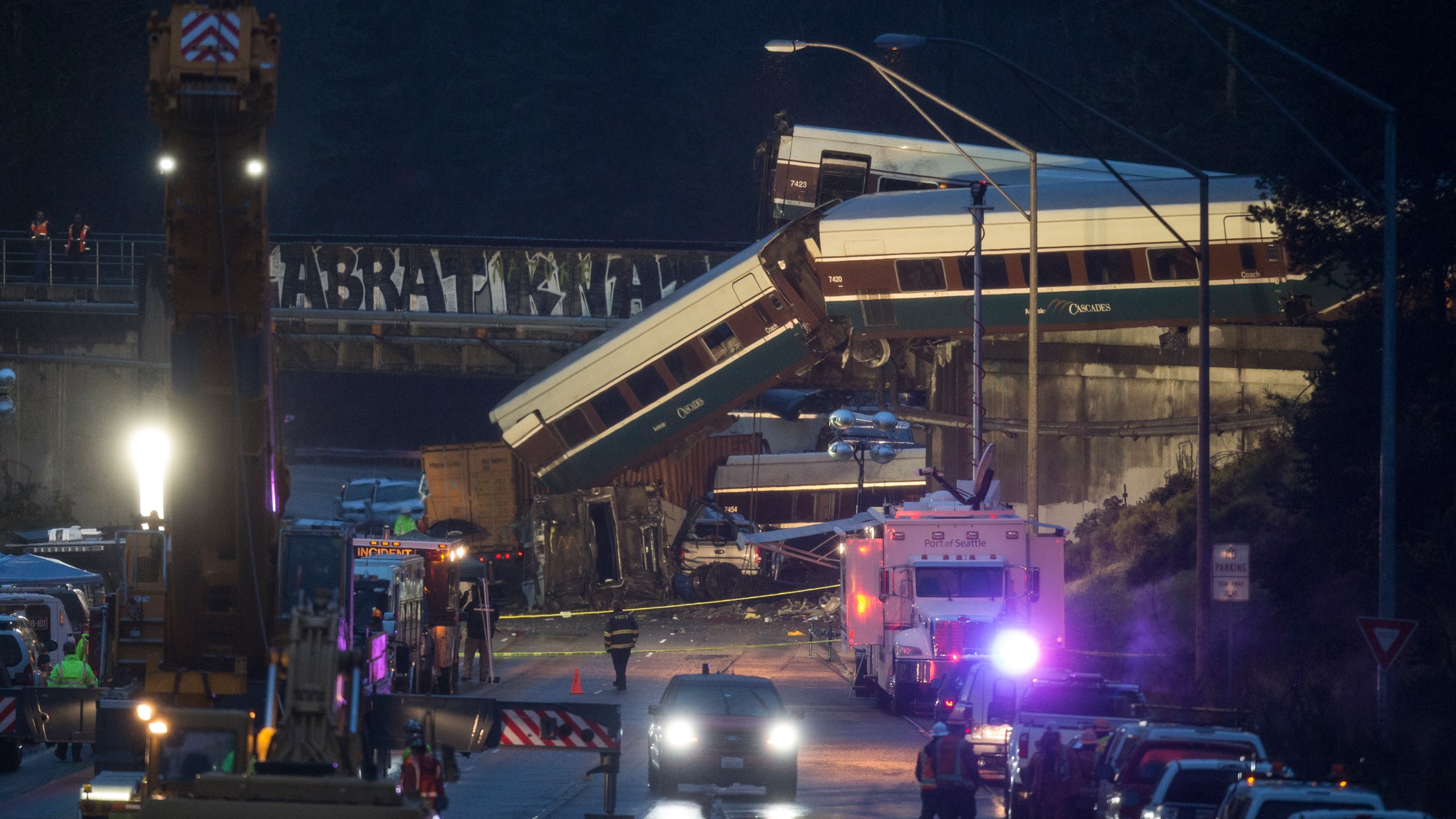 Work crews prepare to clear southbound I-5 lanes at the scene of an Amtrak train derailment on December 18, 2017 in DuPont, Washington. At least six people were killed when several train cars plunged from the bridge. (Credit: Stephen Brashear/Getty Images)