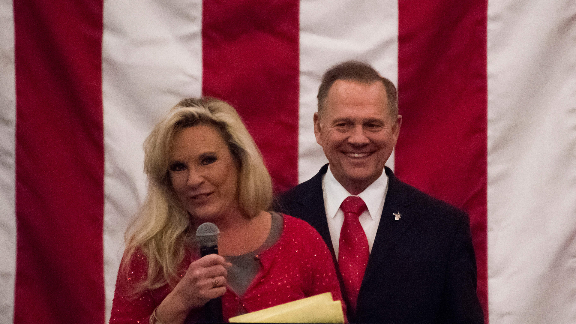 Republican Senatorial candidate Roy Moore smiles as his wife Kayla speaks at a rally in Midland, Alabama, on December 11, 2017. (Credit: JIM WATSON/AFP/Getty Images)