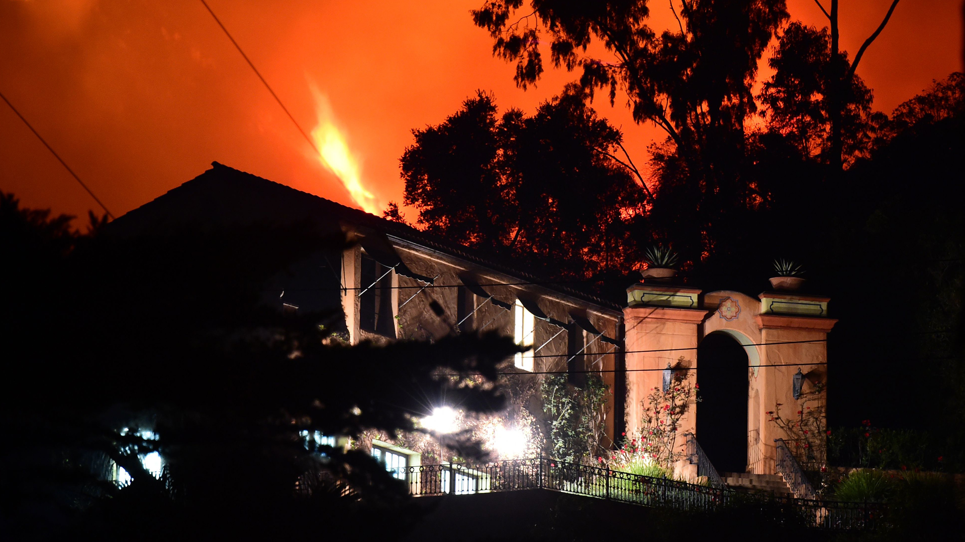 Flames from the Thomas Fire burn in the hills above homes in Montecito on Dec. 11, 2017. Mandatory evacuations were ordered in the area on Dec. 16, 2017. (Credit: Robyn Beck/AFP/Getty Images)