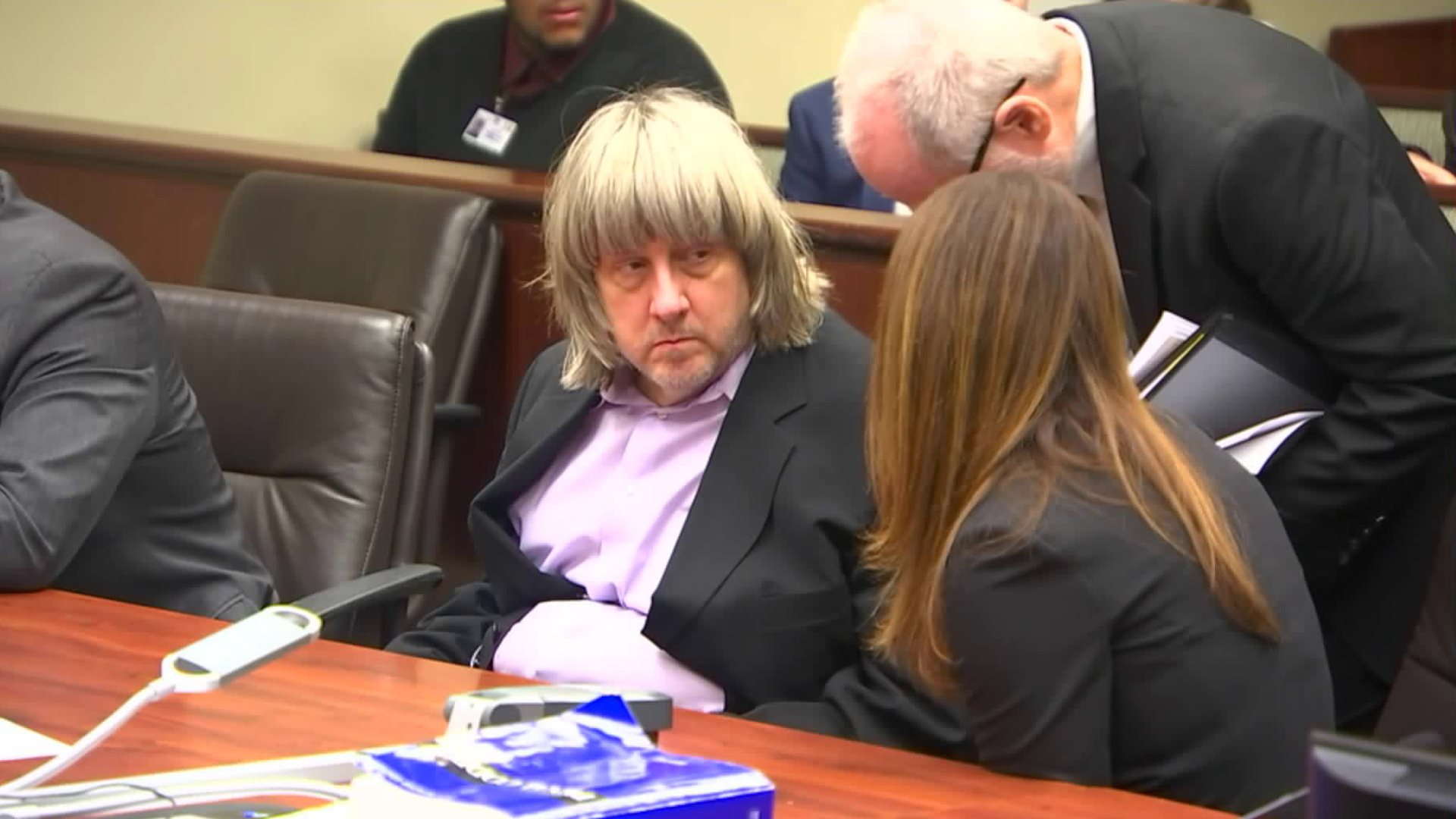 David Turpin is seen talking to public defenders during his arraignment in Riverside on Jan. 18, 2018. (Credit: pool)