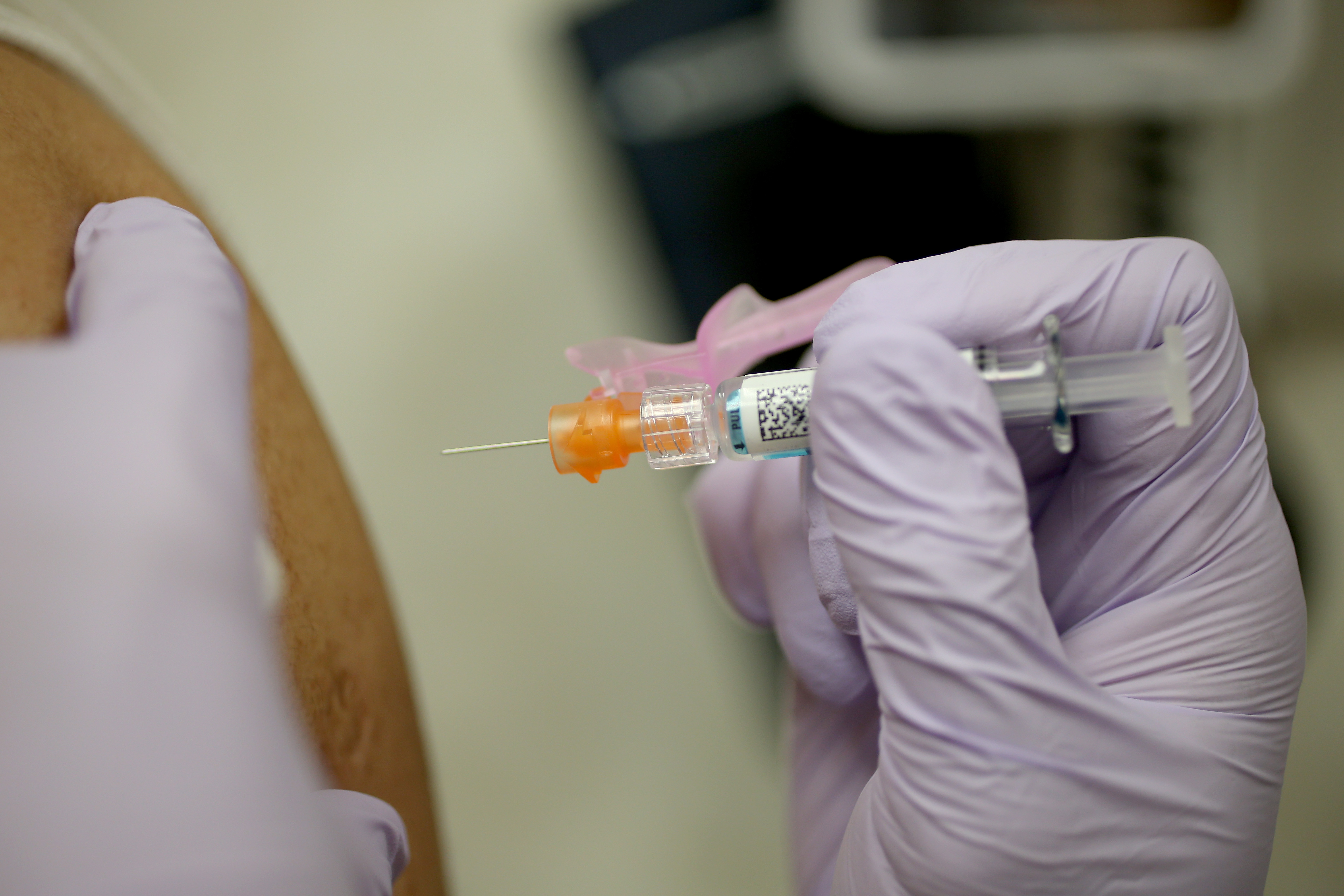 Gautam Gupta receives an influenza shot from Nurse Practitioner Ray Grigorio in the MinuteClinic at the CVS/pharmacy on Jan. 6, 2014 in Fort Lauderdale. (Credit: Joe Raedle/Getty Images)