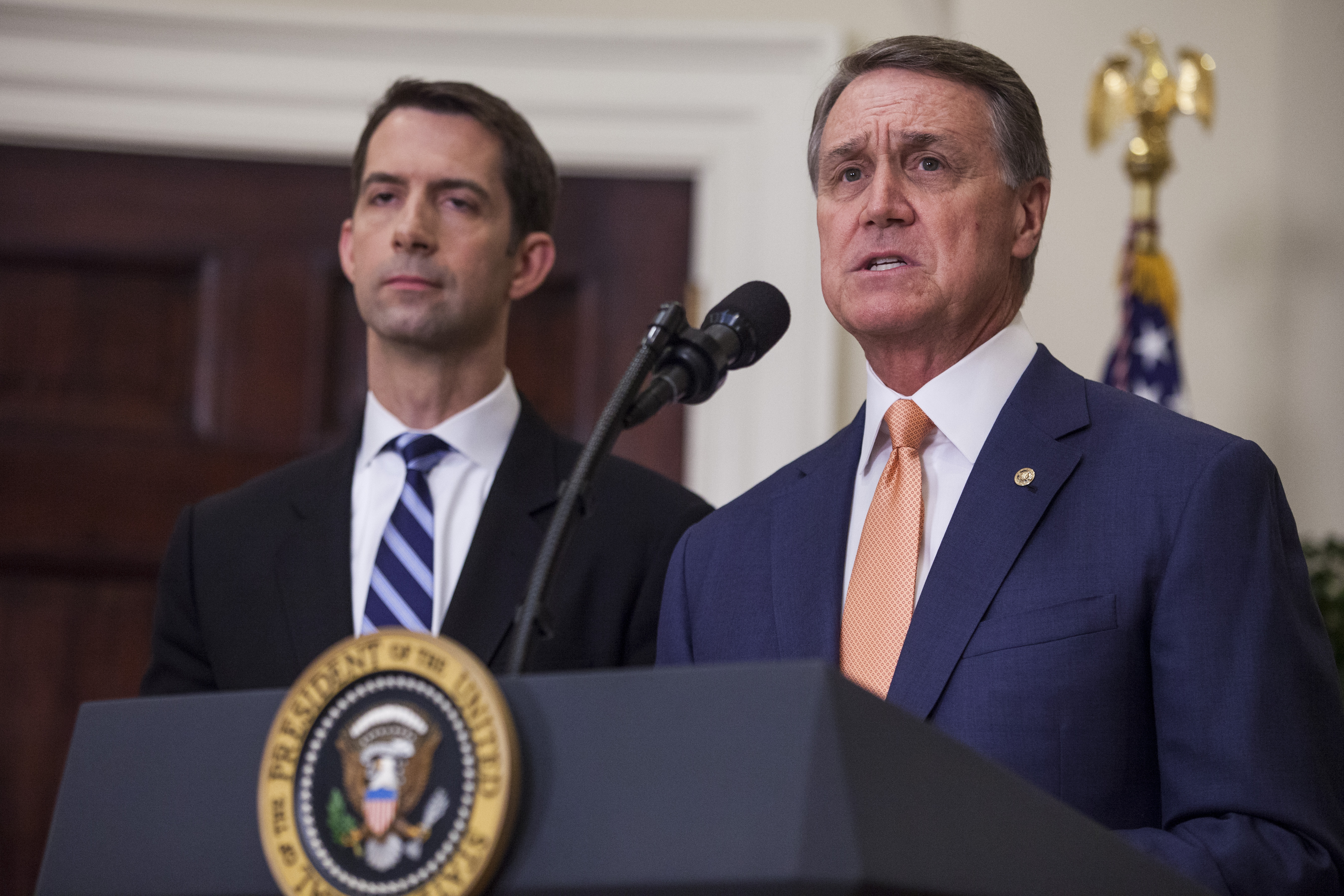 Sen. David Perdue (R-GA), pictured with makes an announcement on the introduction of the Reforming American Immigration for a Strong Economy Act in the Roosevelt Room at the White House on Aug. 2, 2017 in Washington, DC. Sen. Tom Cotton (R-AR).(Credit: Zach Gibson - Pool/Getty Images)