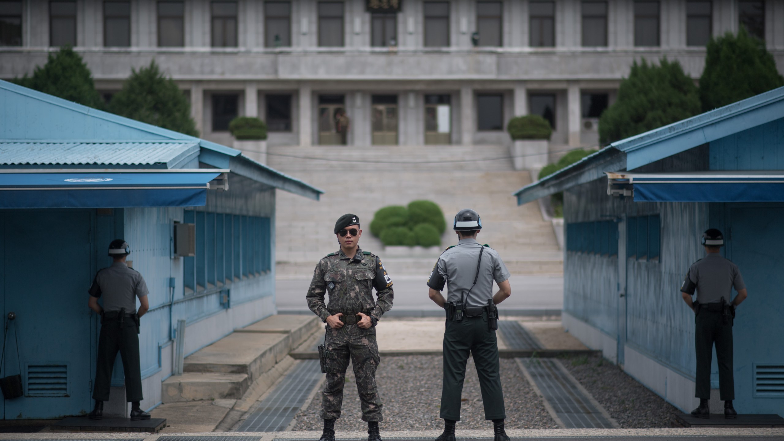 In a photo taken on Aug. 2, 2017, South Korean soldiers stand guard before North Korea's Panmon Hall and the military demarcation line separating North and South Korea, at Panmunjom, in the Joint Security Area of the Demilitarized Zone. (ED JONES/AFP/Getty Images)