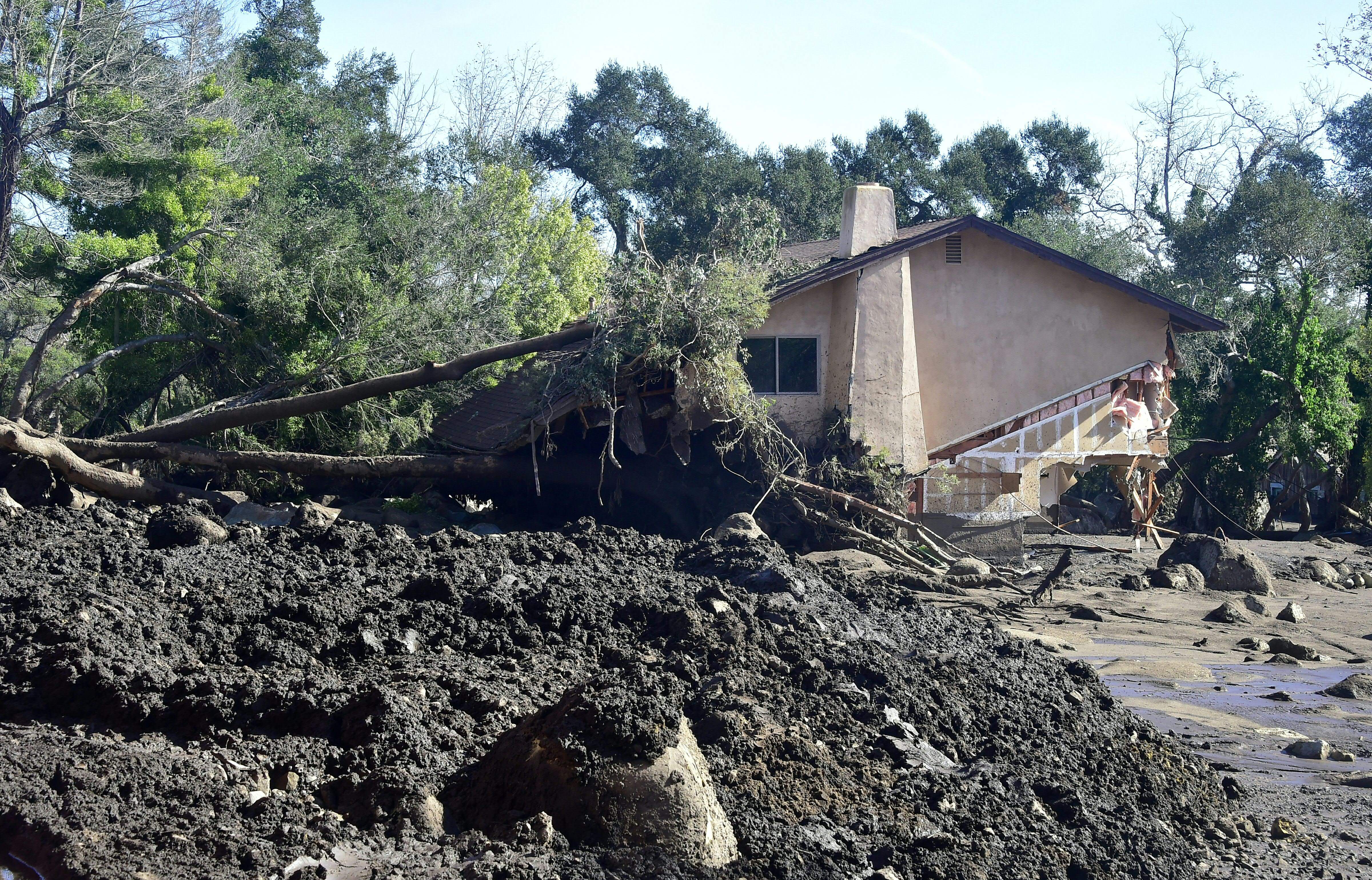 Rocks, mud and uprooted trees surround a demolished property in Montecito on Jan. 12, 2018. (Credit: FREDERIC J. BROWN/AFP/Getty Images)