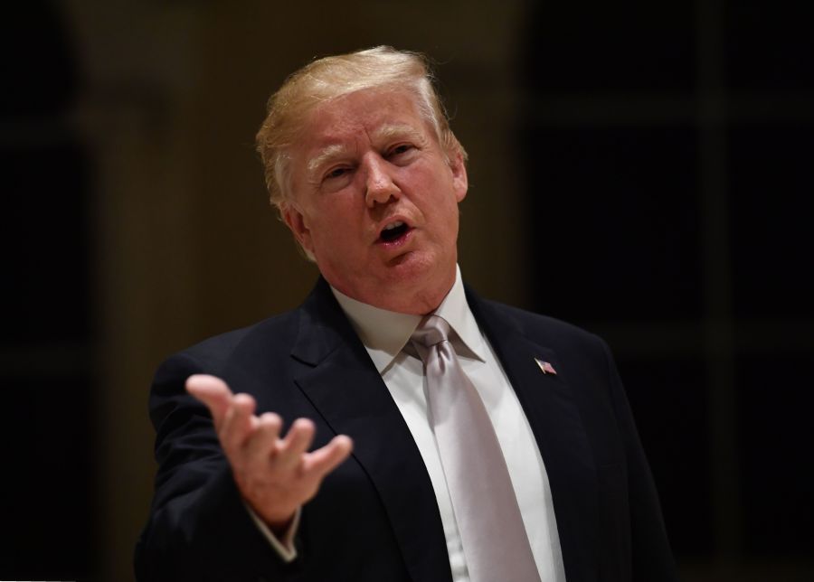 Donald Trump speaks to reporters at Trump International Golf Club in West Palm Beach, Florida on Jan. 14, 2018. (Credit: NICHOLAS KAMM/AFP/Getty Images)