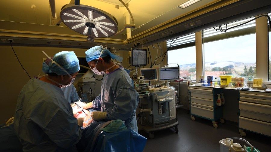 Surgical oncologist Max Buttarelli carries out intraoperative radiation therapy on a breast cancer patient on Nov. 2, 2017, in the surgical unit of the Paoli-Calmettes Institute in Marseille, France. (Credit: ANNE-CHRISTINE POUJOULAT/AFP/Getty Images)