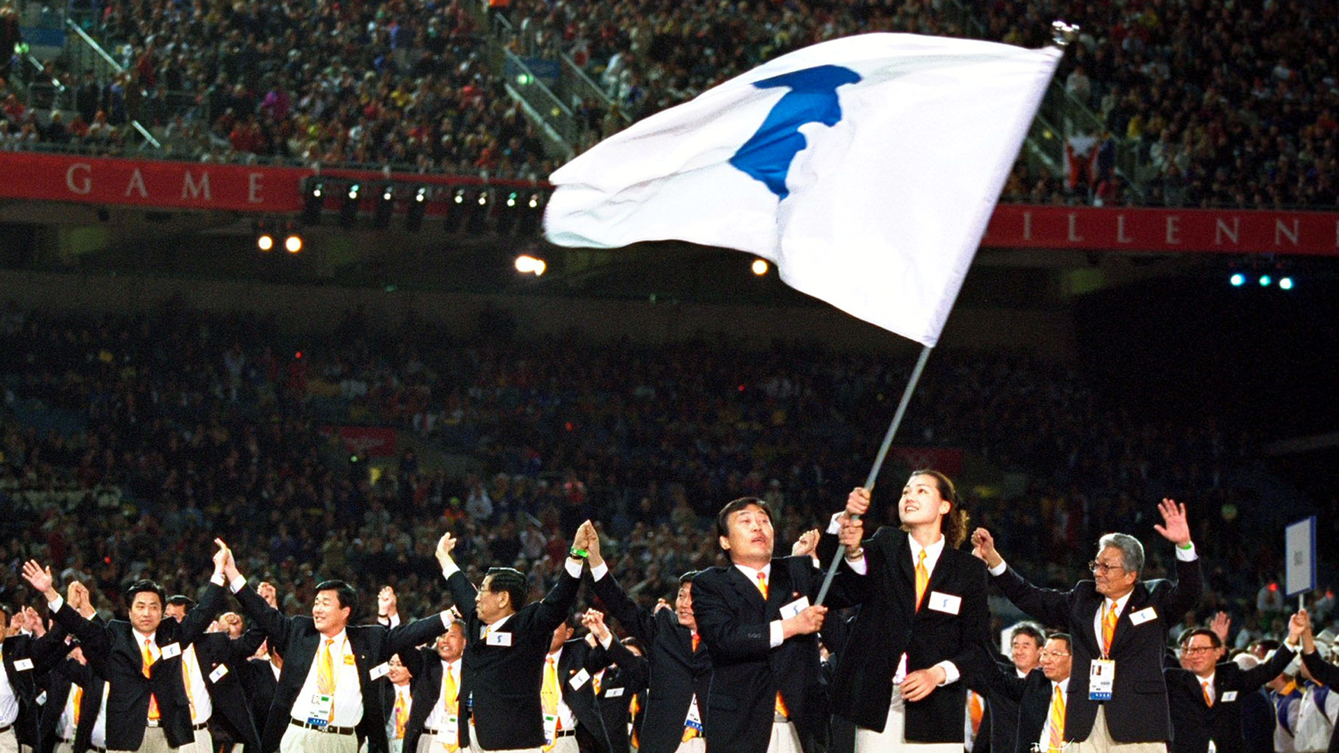 The two Korean Olympic teams walk round together under the same flag in a gesture of reconciliation during the Opening Ceremony of the Sydney 2000 Olympic Games at the Olympic Stadium in Homebush Bay, Sydney, Australia. (Credit: Jed Jacobsohn /Allsport)