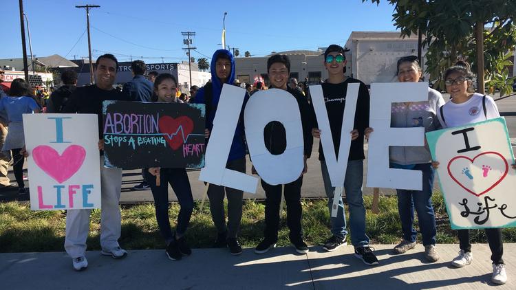 The youth ministry from the St. Angela Merici Catholic Church in Brea attends the OneLife LA march in Chinatown on Jan. 20, 2018. (Credit: Deborah Netburn / Los Angeles Times)