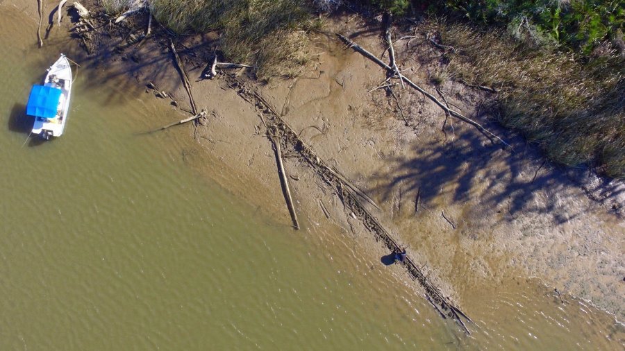 In a remote river delta on Alabama's Gulf coast, partially hidden under water and mud, may be the answer to a mystery that has baffled scholars for more than 150 years. (Credit: Ben Raines / AP via CNN)