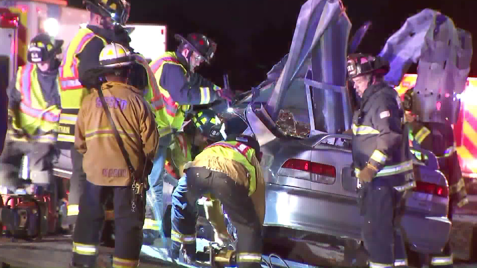 A rescue crew responds to a car impaled on a guard rail in Santa Fe Springs on Jan. 30, 2018. (KTLA)