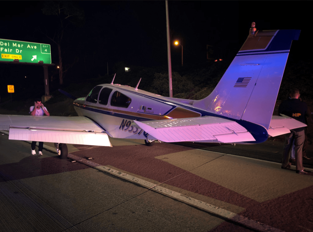 The pilot of a beachcraft bonanza that landed on the 55 Freeway in Costa Mesa talks on a cellphone on Jan. 28, 2018. (Credit: Costa Mesa Fire Department)