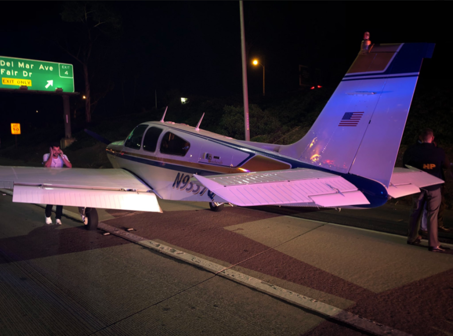 The pilot of a beachcraft bonanza that landed on the 55 Freeway in Costa Mesa talks on a cellphone on Jan. 28, 2018. (Credit: Costa Mesa Fire Department)