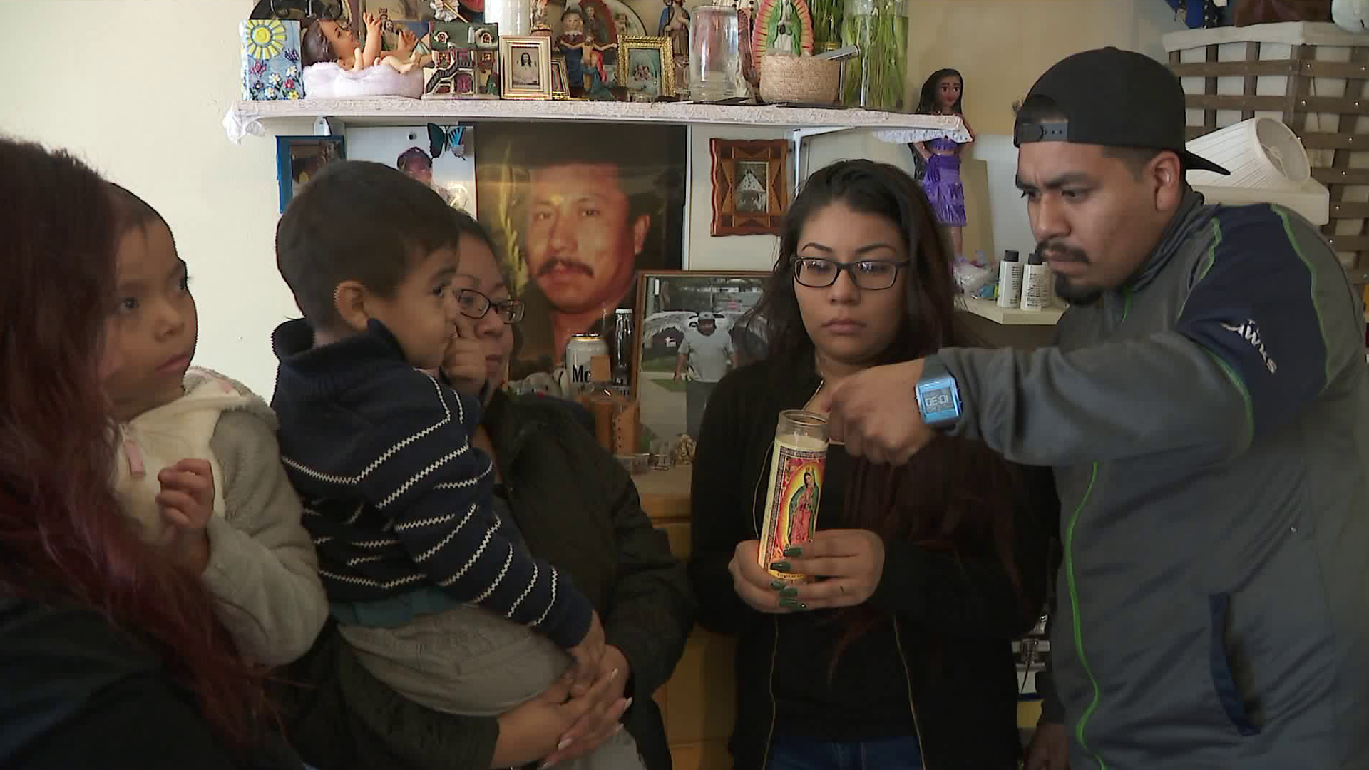 Lucio Garcia's family light a candle for a shrine set up in his honor on Jan. 11, 2018. (Credit: KTLA)