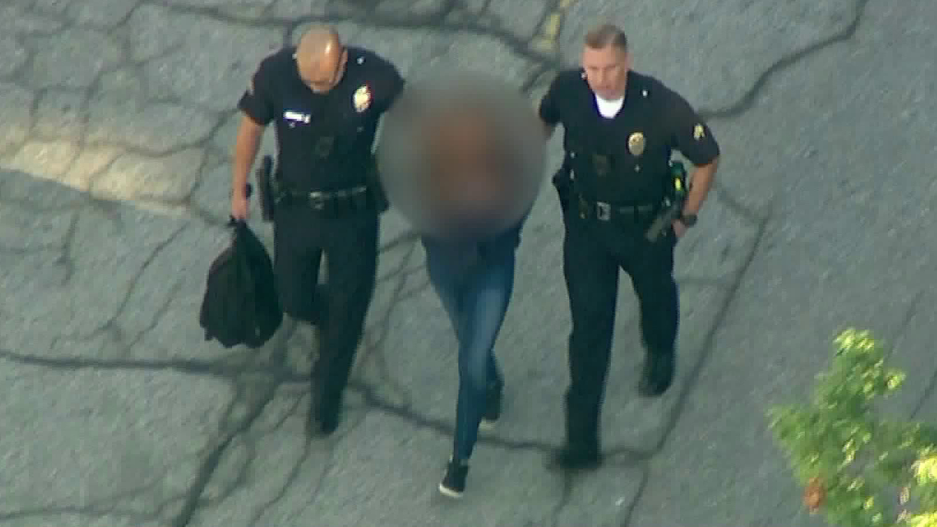 Police lead a 12-year-old suspect away from Sal Castro Middle school following a shooting on Feb. 1, 2018. (Credit: KTLA)