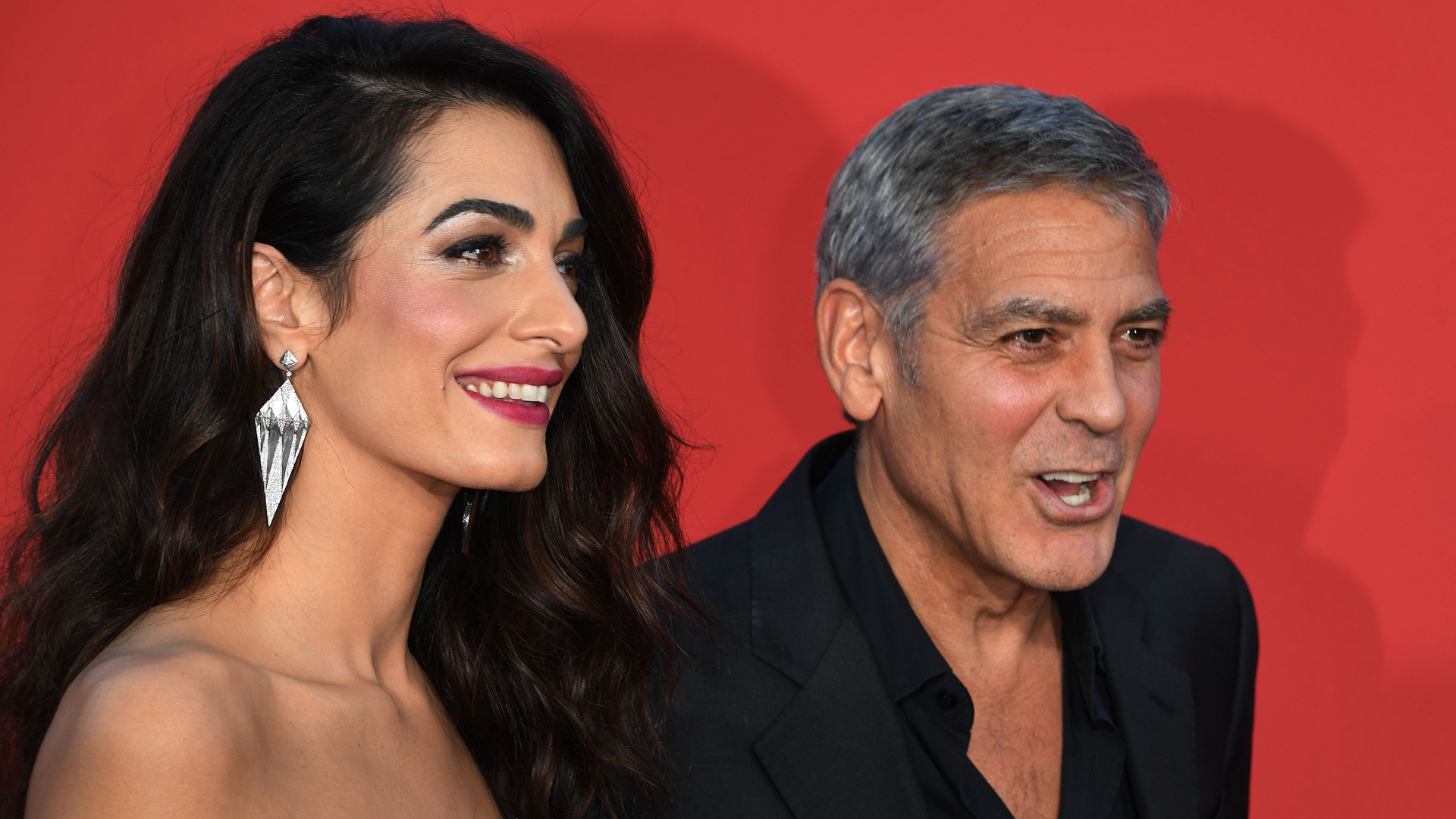 George Clooney and his wife Amal Clooney arrive for the Premiere of Paramount Pictures 'Suburbicon' at the Regency Village Theatre in Westwood, on October 22, 2017. (Credit: MARK RALSTON/AFP/Getty Images)