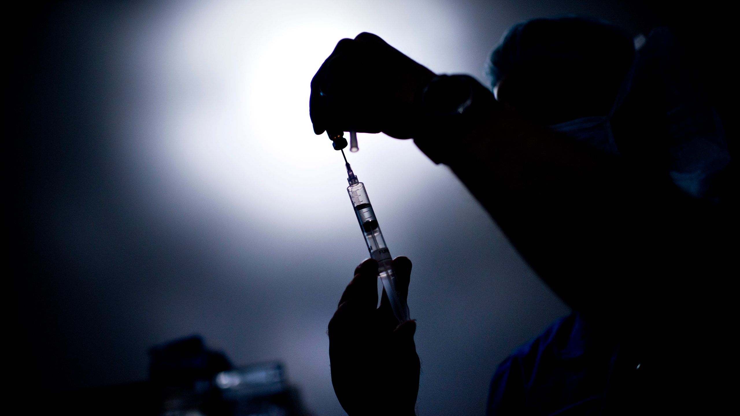 A doctor draws medicine into a syringe in this file photo. (Credit: BRENDAN SMIALOWSKI/AFP/GettyImages)