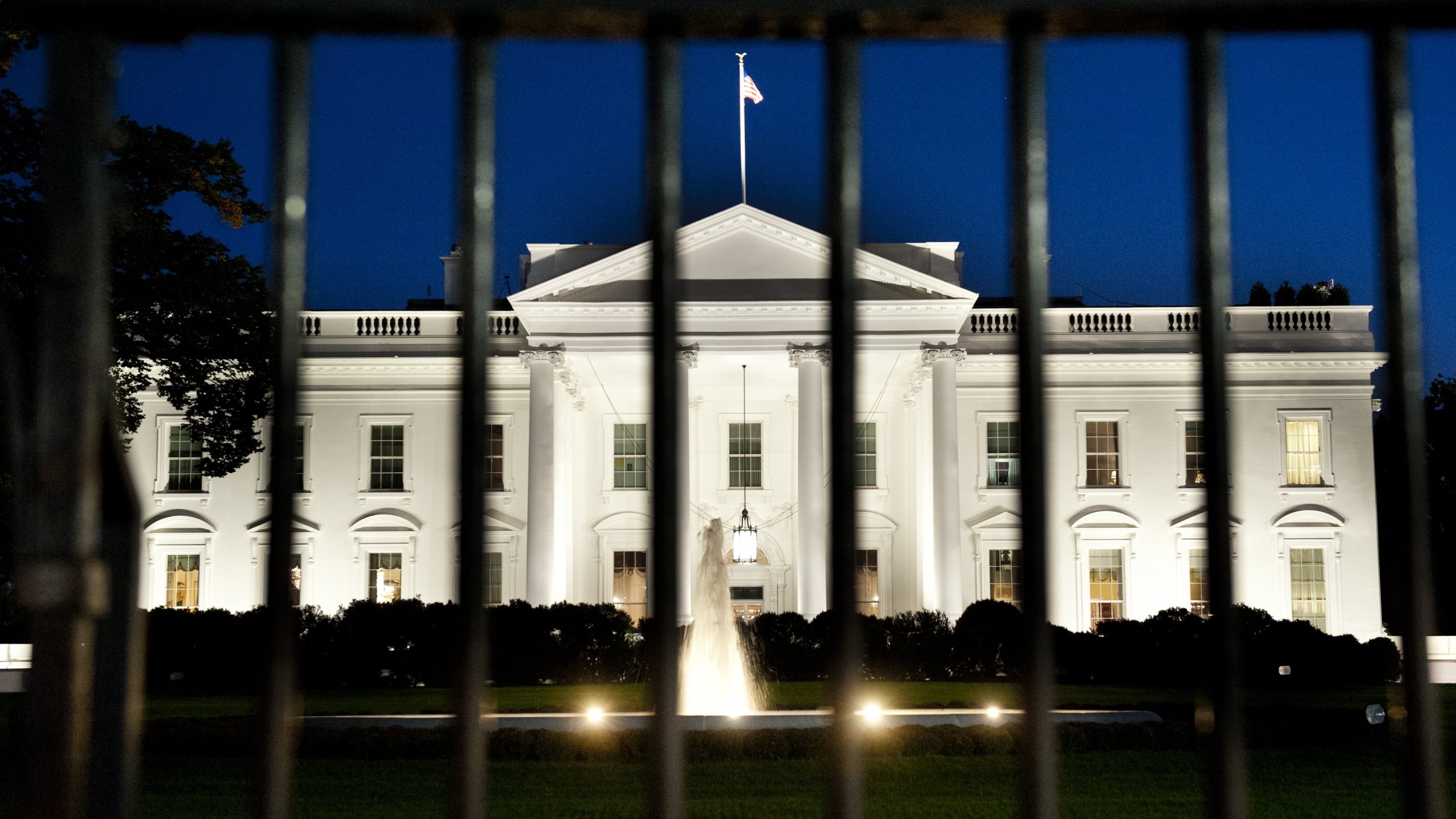 The White House is seen at dusk on the eve of a possible government shutdown as Congress battles out the budget in Washington, D.C, on Sept. 30, 2013. (Credit: Saul Loeb/AFP/Getty Images)