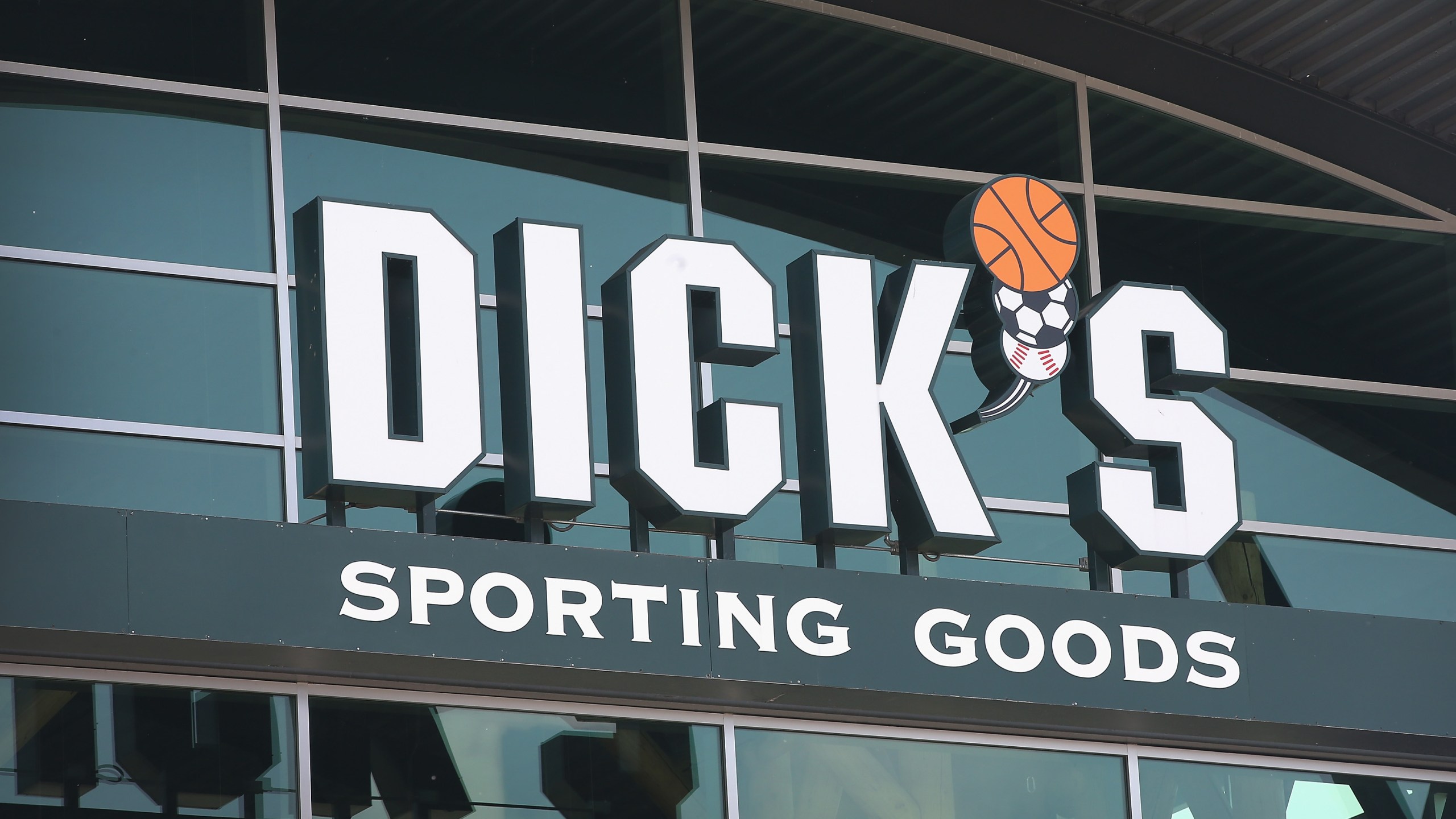 A sign with the company logo hangs above the entrance of a Dick's Sporting Goods store on May 20, 2014 in Niles, Illinois. (Credit: cott Olson/Getty Images)