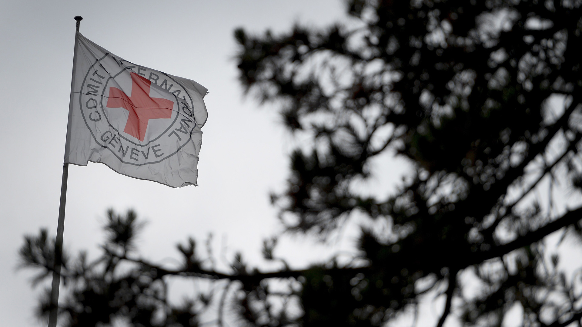 A flag floats at the top of the International Committee of the Red Cross headquarters in Geneva, Switzerland on June 4, 2014. (Credit: FABRICE COFFRINI/AFP/Getty Images)