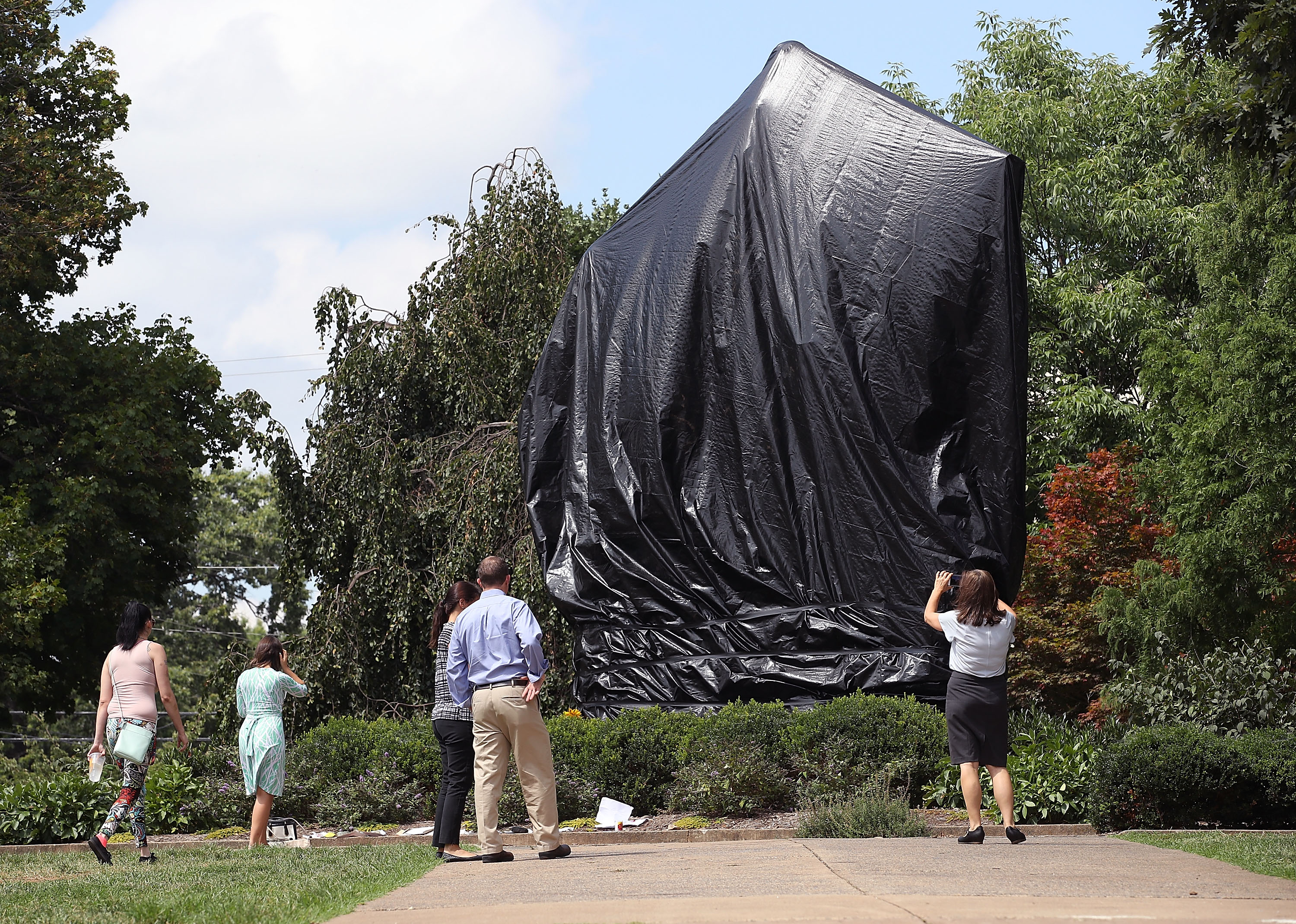 A statue of Confederate Gen. Robert E. Lee is covered with a black tarp as it stands in the center of Emancipation Park, formerly Lee Park, in Charlottesville, Virginia, on Aug. 23, 2017, the same week the Charlottesville city council voted unanimously to cover Confederate statues in black tarp. (Credit: Mark Wilson / Getty Images)