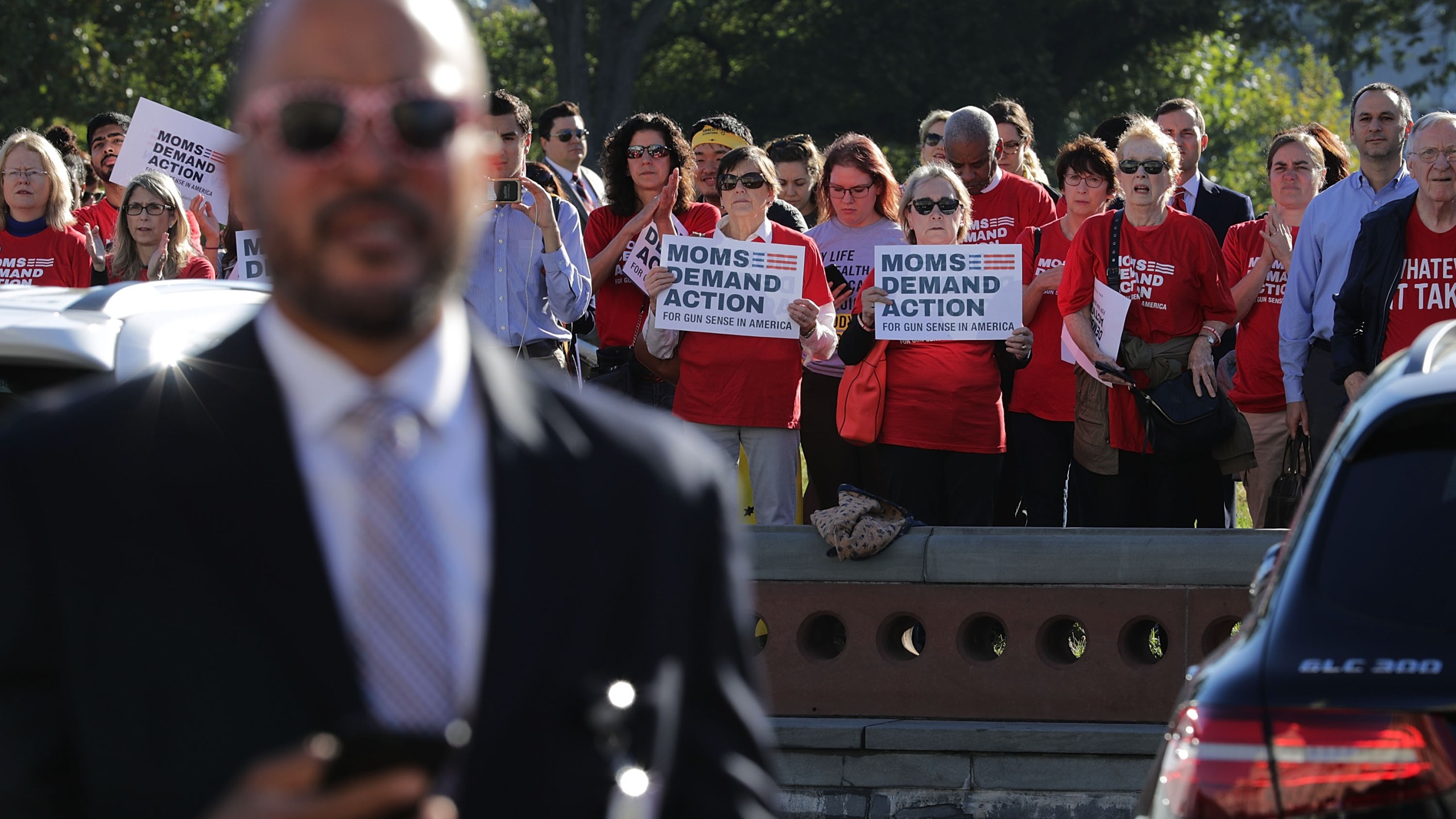 Anti-gun violence activists from Moms Demand Action stand at a distance as House Democrats rally on the East Front steps of the U.S. House of Representatives Oct. 4, 2017, in Washington, D.C. (Credit: Chip Somodevilla/Getty Images)