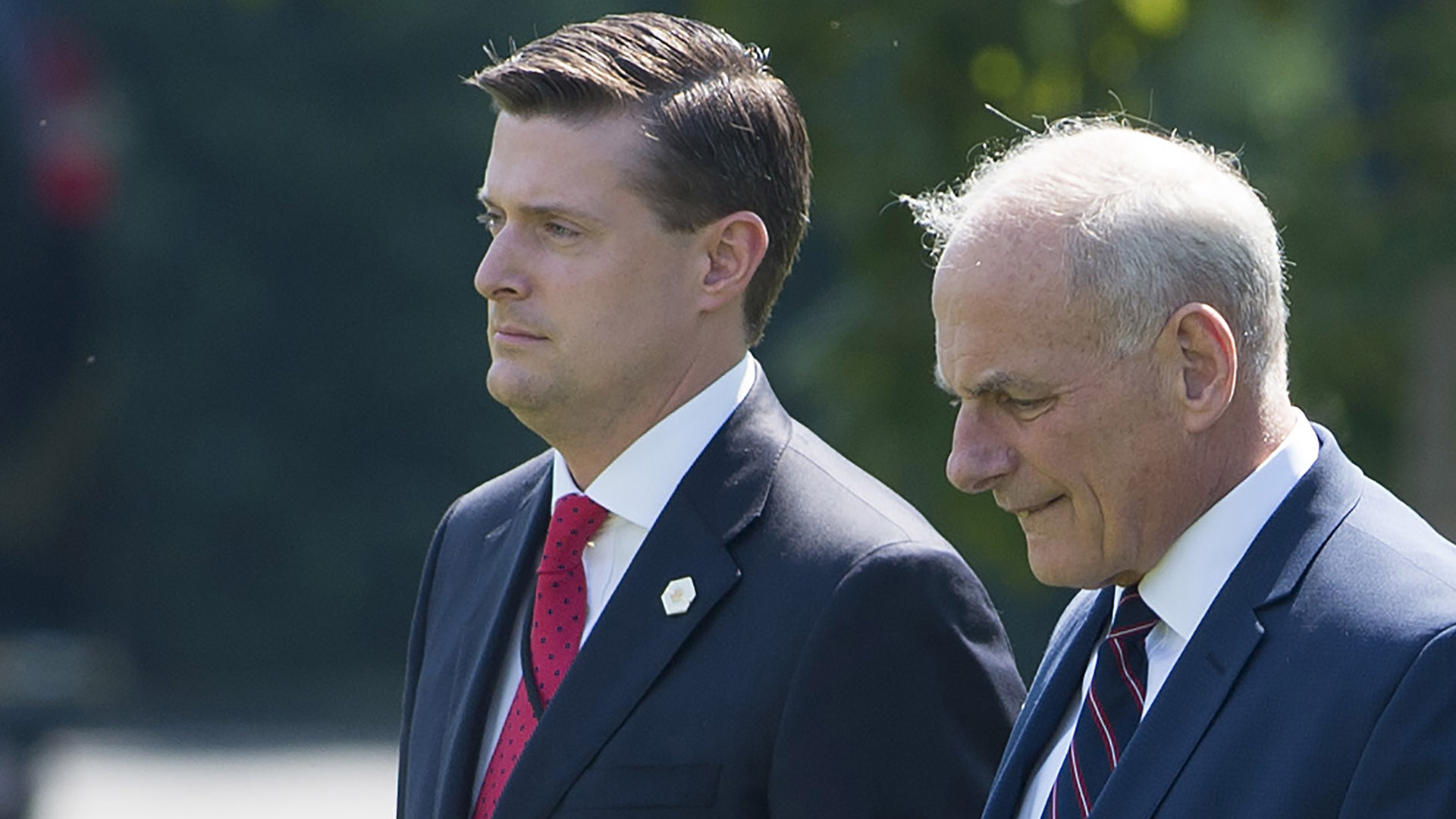 John Kelly, right, and Rob Porter walk to Marine One prior to departure from the South Lawn of the White House in Washington, D.C. on Aug. 4, 2017. (Credit: SAUL LOEB/AFP/Getty Images)