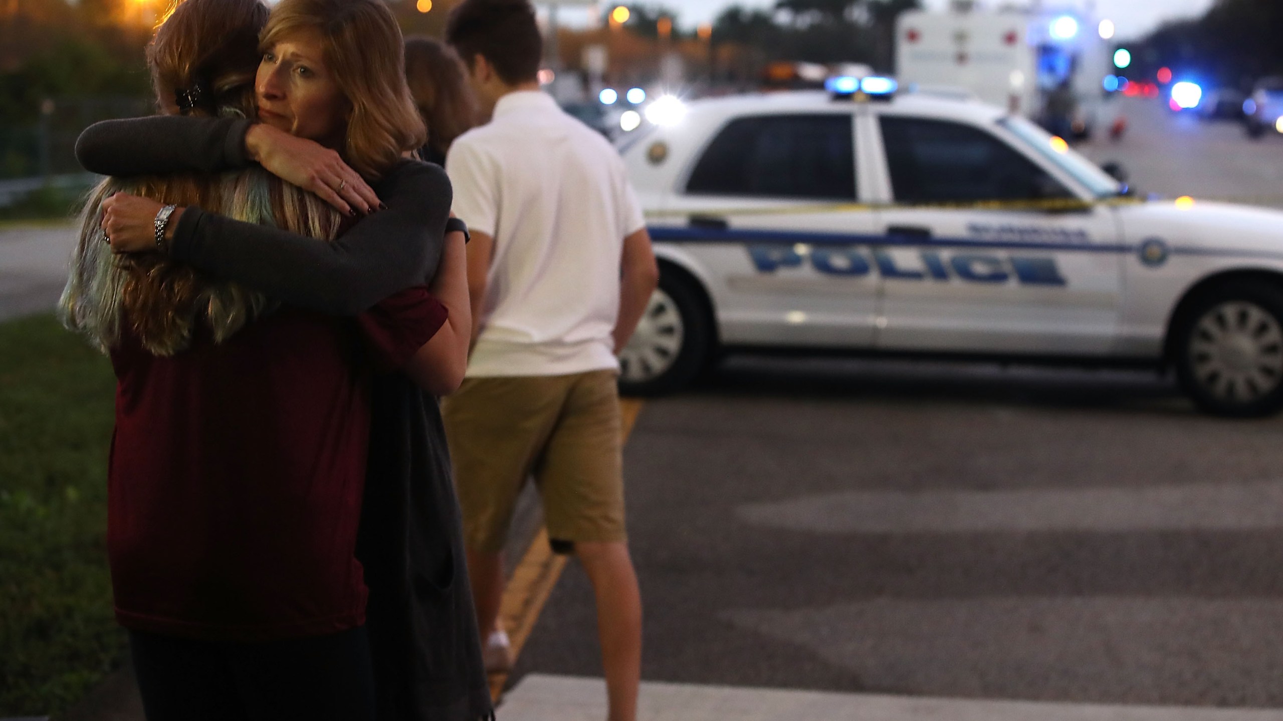 Kristi Gilroy hugs a young woman at a police check point near the Marjory Stoneman Douglas High School on Feb. 15, 2018, in Parkland, Florida. (Credit: Mark Wilson/Getty Images)