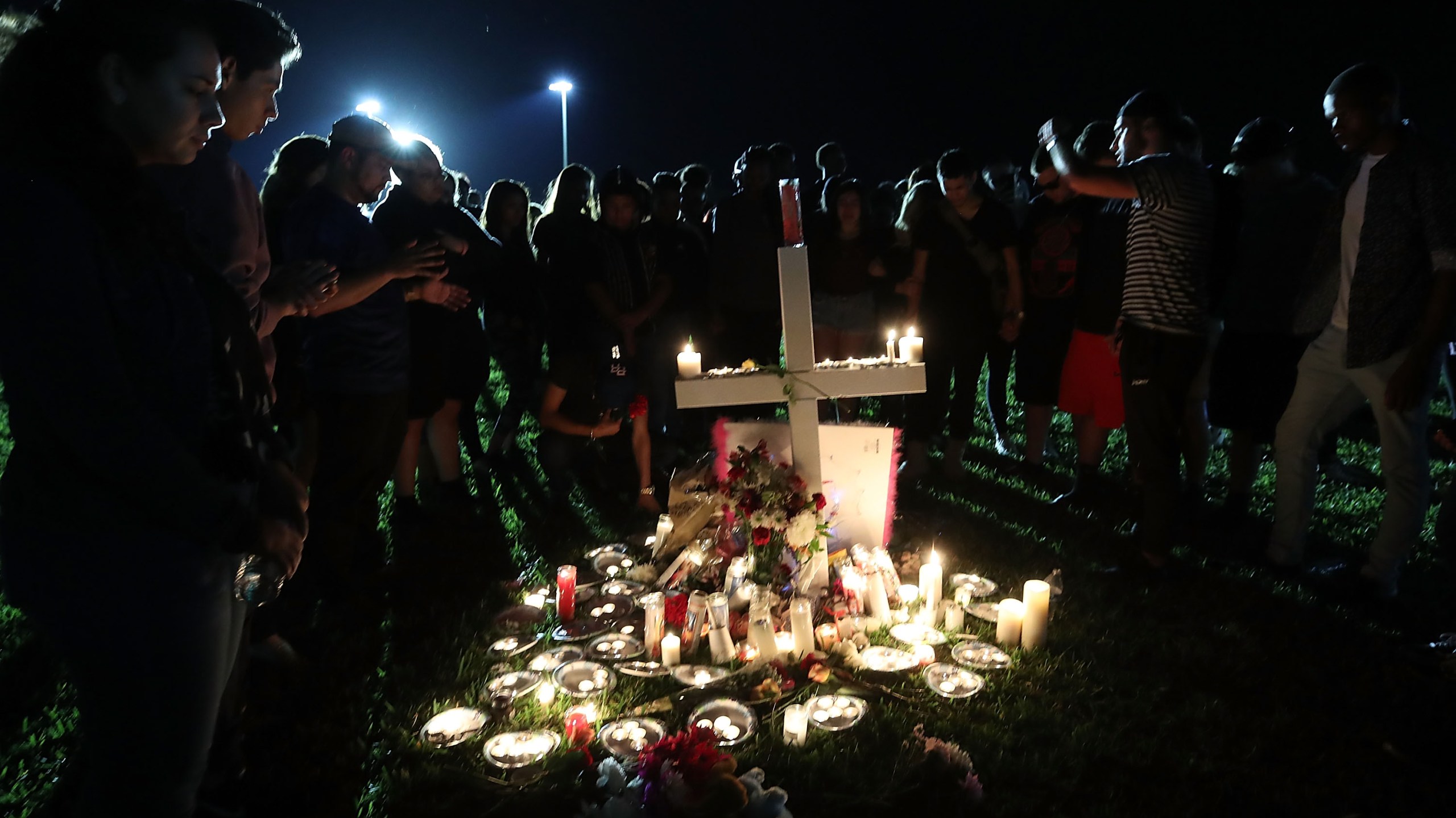 Students, friends and family gather to pray during a candlelight vigil for victims of the mass shooting at Marjory Stoneman Douglas High School, in Parkland, Florida, on Feb. 15, 2018. (Credit: Mark Wilson / Getty Images)