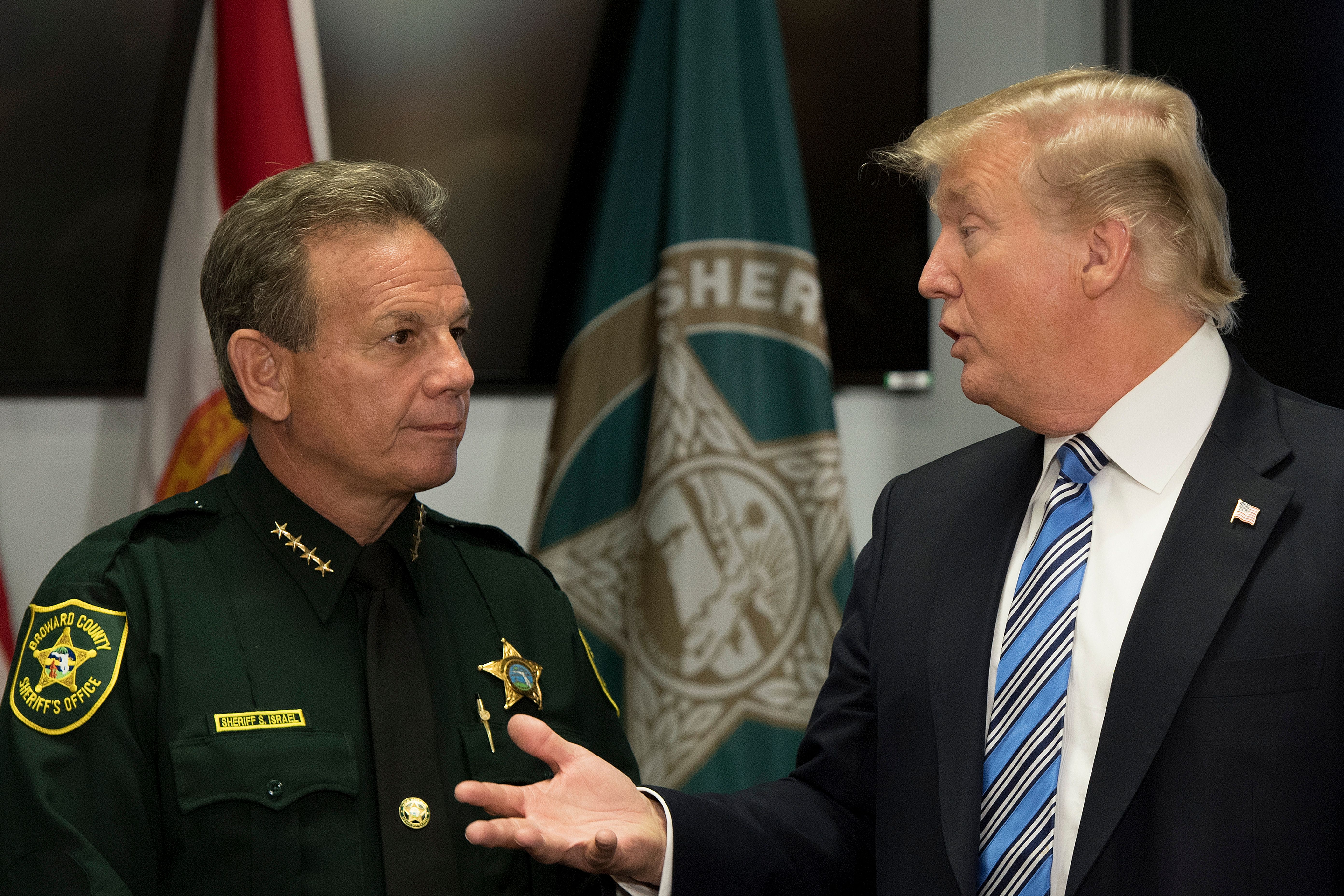 President Donald Trump speaks with Broward County Sheriff Scott Israel while visiting first responders at Broward County Sheriff's Office on Feb. 16, 2018, three days after a mass shooting that claimed 17 lives at a nearby high school. (Credit: Jim Watson / AFP / Getty Images)