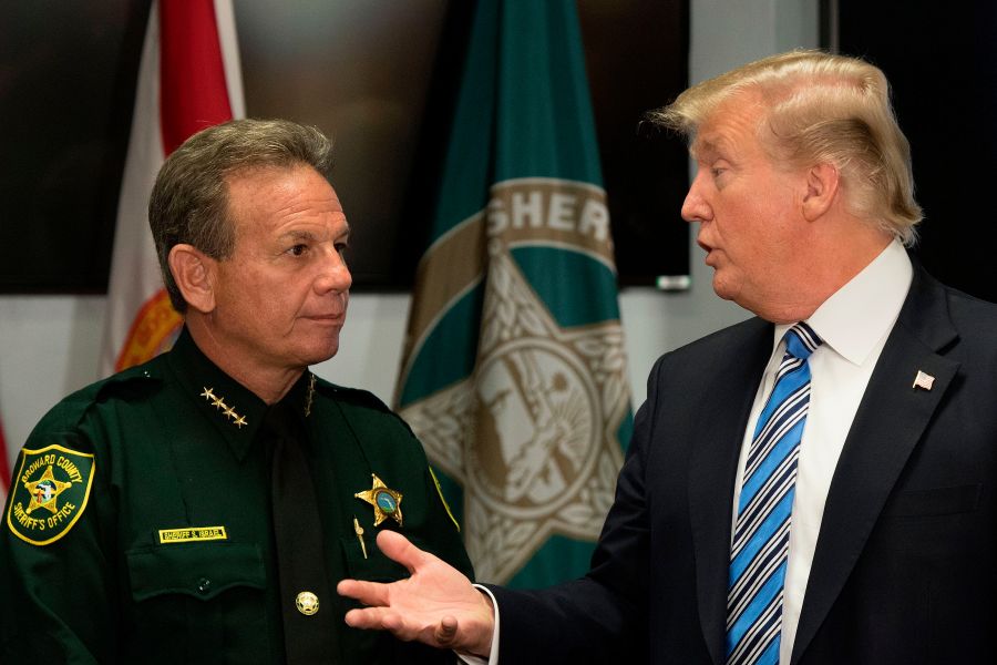 President Donald Trump speaks with Broward County Sheriff Scott Israel while visiting first responders at Broward County Sheriff's Office on Feb. 16, 2018, three days after a mass shooting that claimed 17 lives at a nearby high school. (Credit: Jim Watson / AFP / Getty Images)