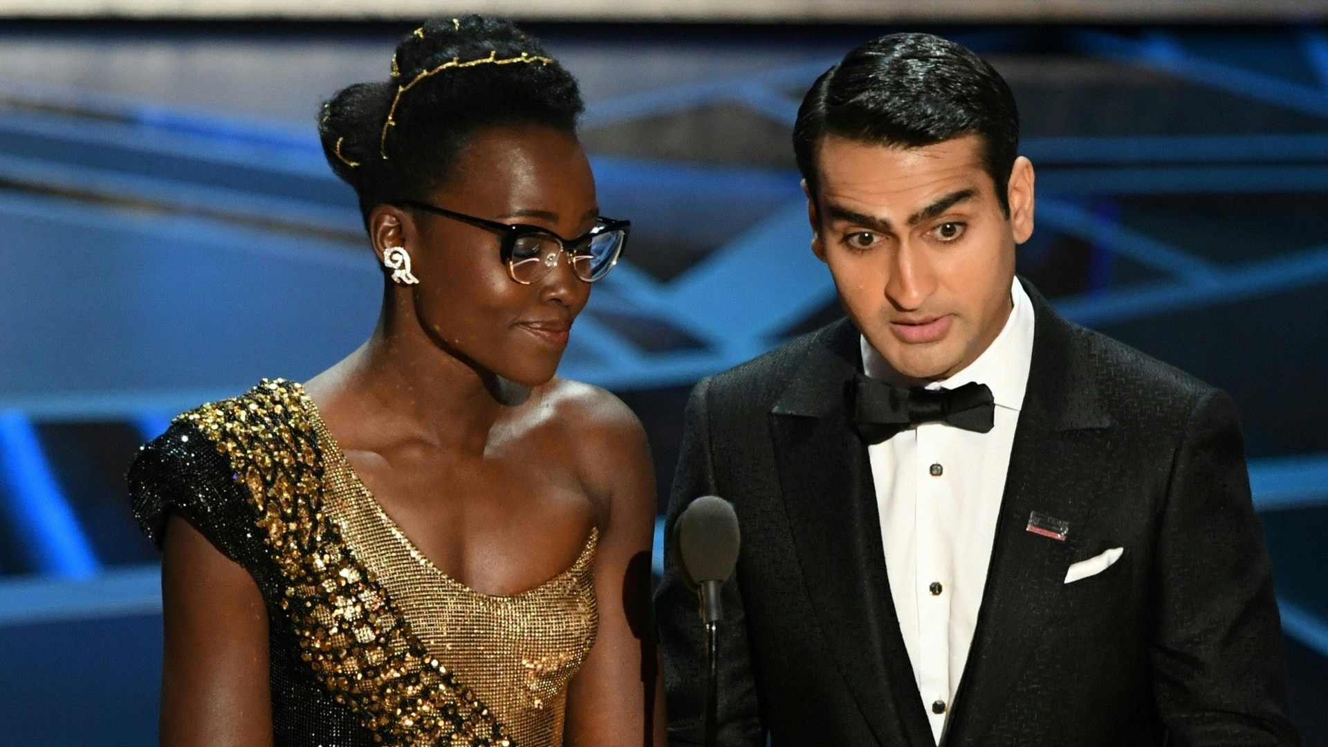 Kenyan-Mexican actress Lupita Nyong'o and Pakistani-American stand-up comedian Kumail Nanjiani present the Oscar for Best Production Design during the 90th Annual Academy Awards show on March 4, 2018 in Hollywood. (Credit: MARK RALSTON/AFP/Getty Images)