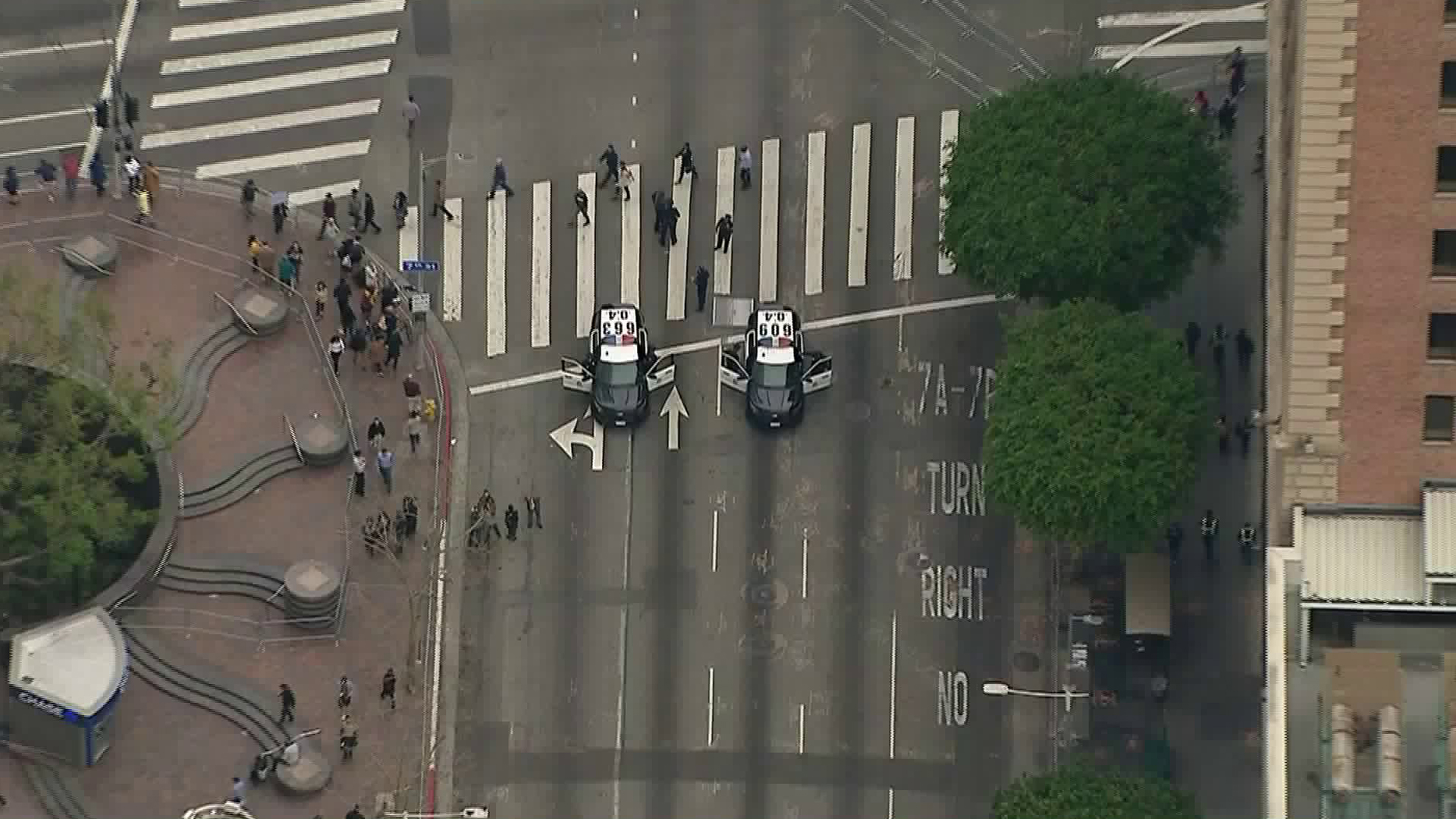 LAPD officers block traffic in downtown Los Angeles on March 13, 2018, in advance of President Trump's visit. (Credit: KTLA)