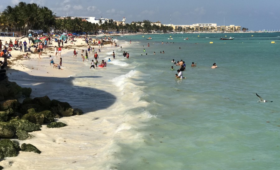 Tourists enjoy the beach at the Playa del Carmen in Quintana Roo state, Mexico, on March 28, 2017. (Credit: Daniel Slim / AFP / Getty Images)