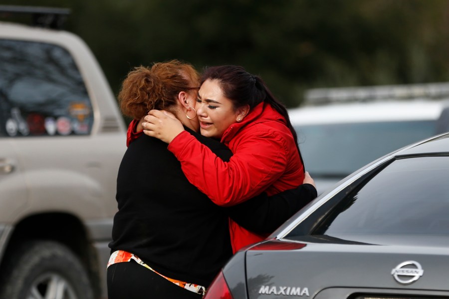 Vanessa Flores, right, embraces another woman after she leaves the locked down Veterans Home of California during an active shooter turned hostage situation on March 9, 2018, in Yountville, California. (Credit: Stephen Lam / Getty Images)