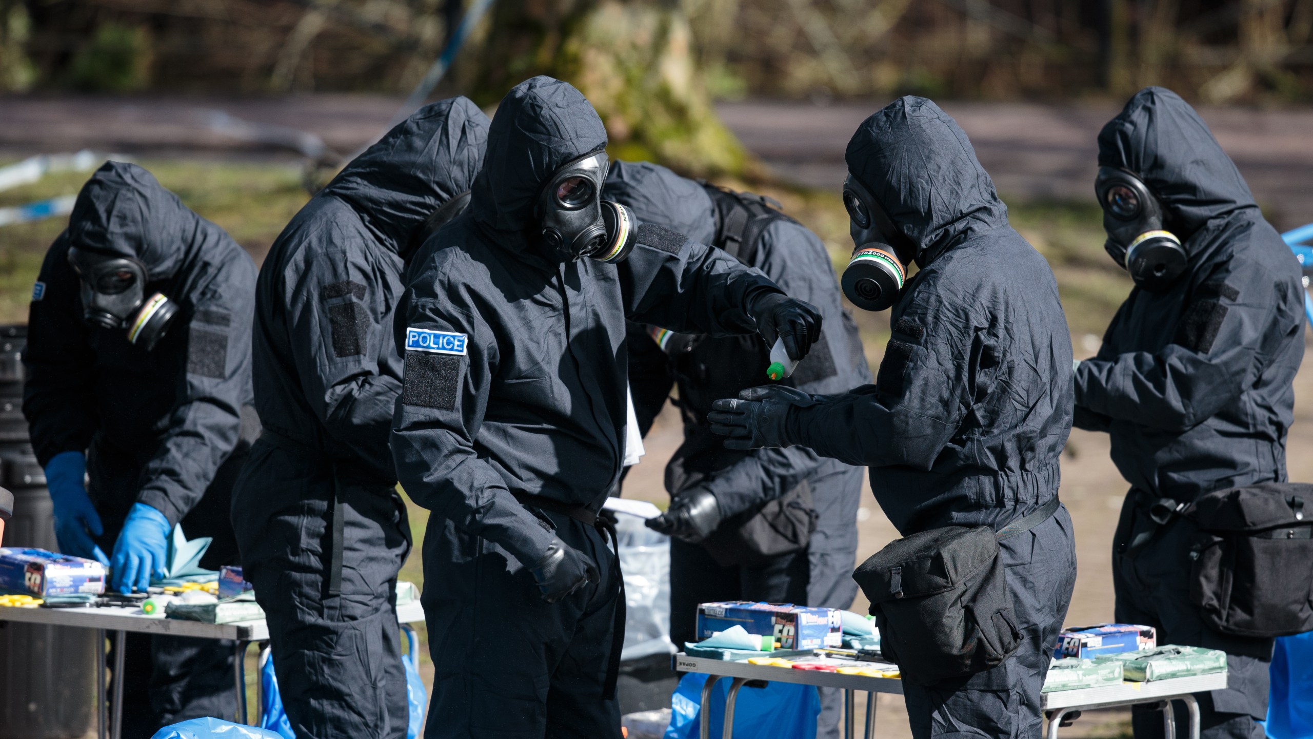 Police officers in protective suits and masks work near the scene where former double-agent Sergei Skripal and his daughter, Yulia were discovered after being attacked with a nerve-agent on March 16, 2018 in Salisbury, England. (Credit: Jack Taylor/Getty Images)