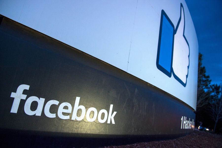 A lit sign is seen at the entrance to Facebook's corporate headquarters location in Menlo Park on March 21, 2018. (Credit: Josh Edelson/AFP/Getty Images)