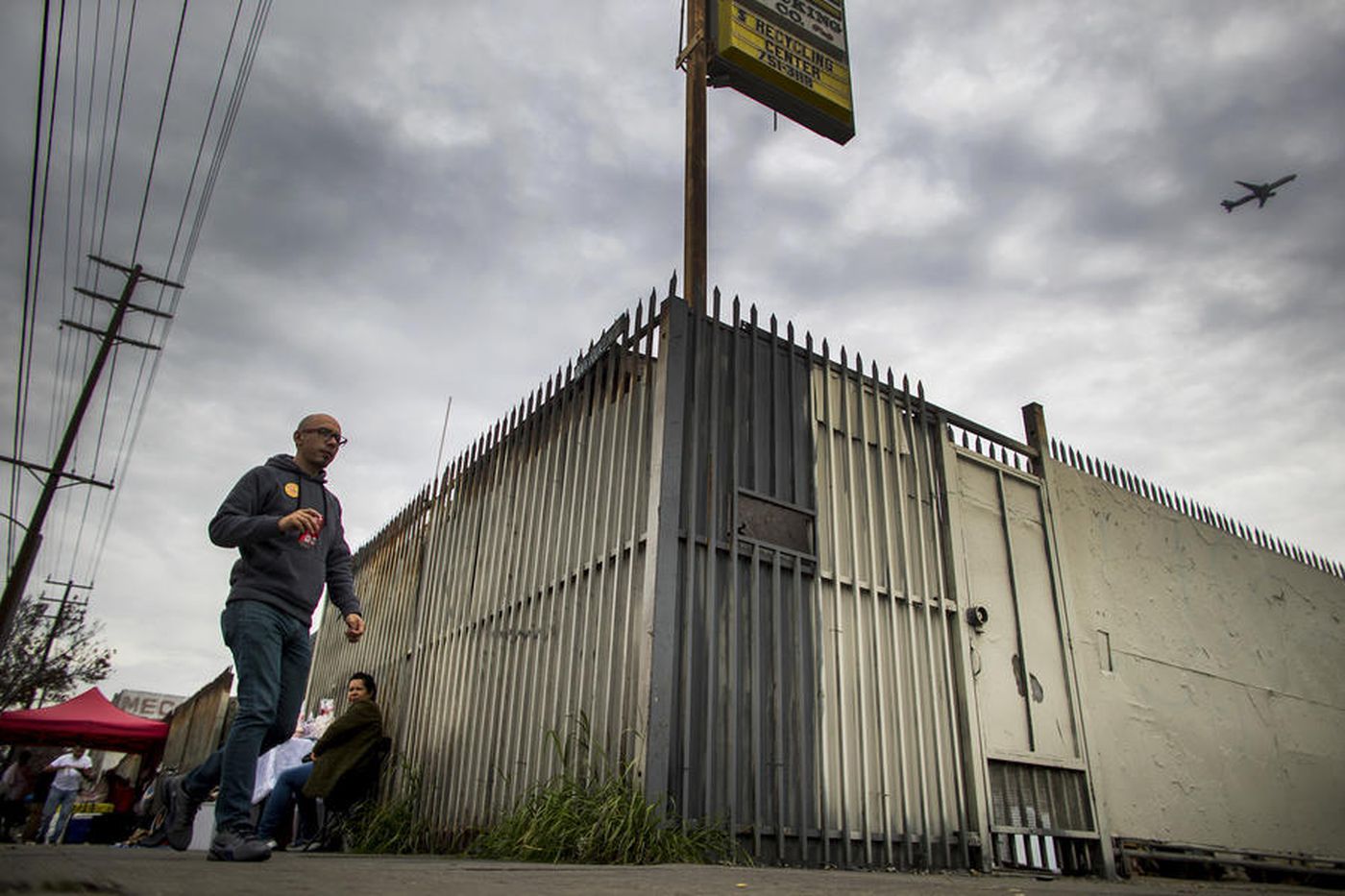 This undated photo shows a man walking by a lot that was slated for a homeless housing project in the 400 block of East Florence Avenue in Los Angeles. (Credit: Gina Ferazzi / Los Angeles Times)