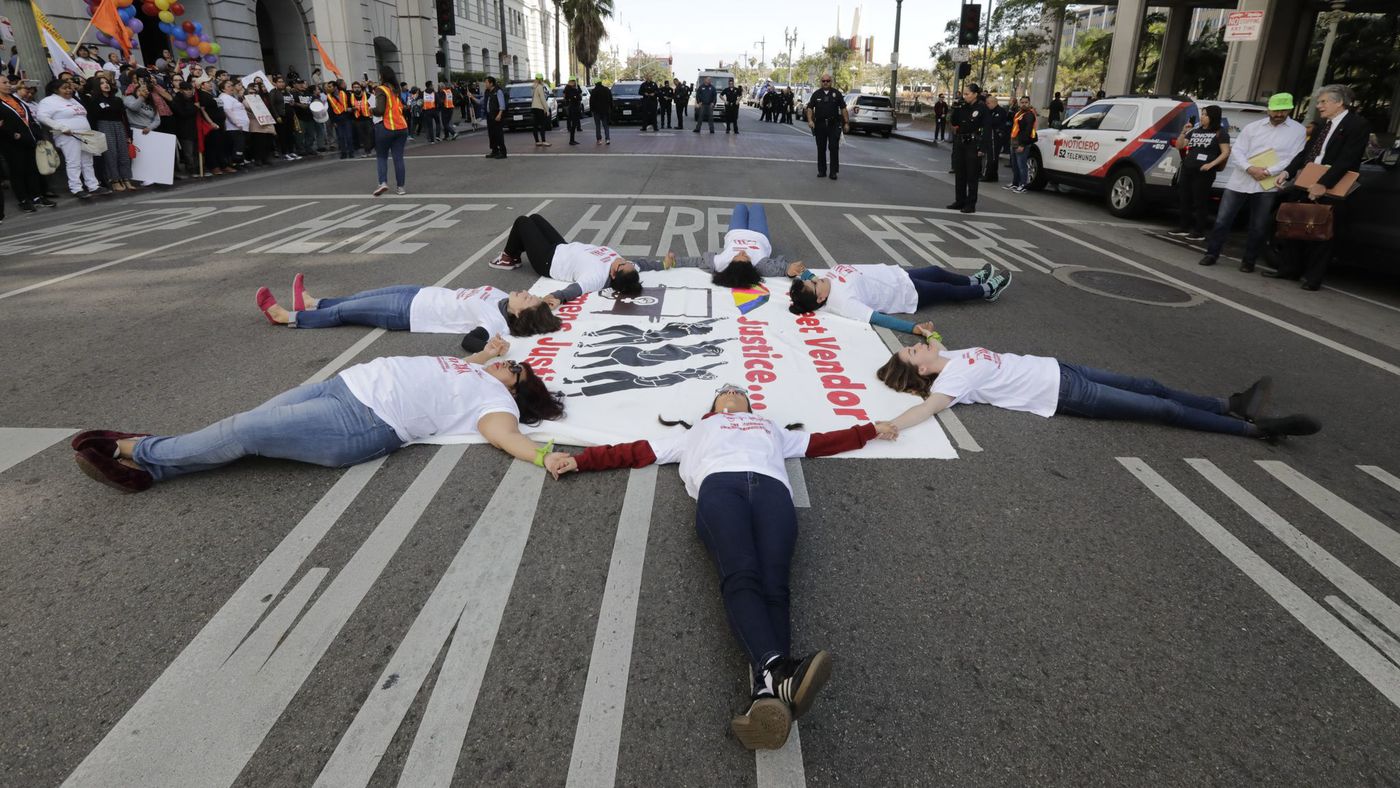 Leaders of the L.A. Street Vendor Campaign block Main Street near Los Angeles City Hall on March 9, 2018. (Credit: Irfan Khan / Los Angeles Times)