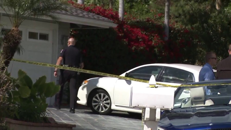 Two dead bodies were found inside a home in Orange, where detectives are seen investigating the scene later that same day on March 14, 2018. (Credit: KTLA)