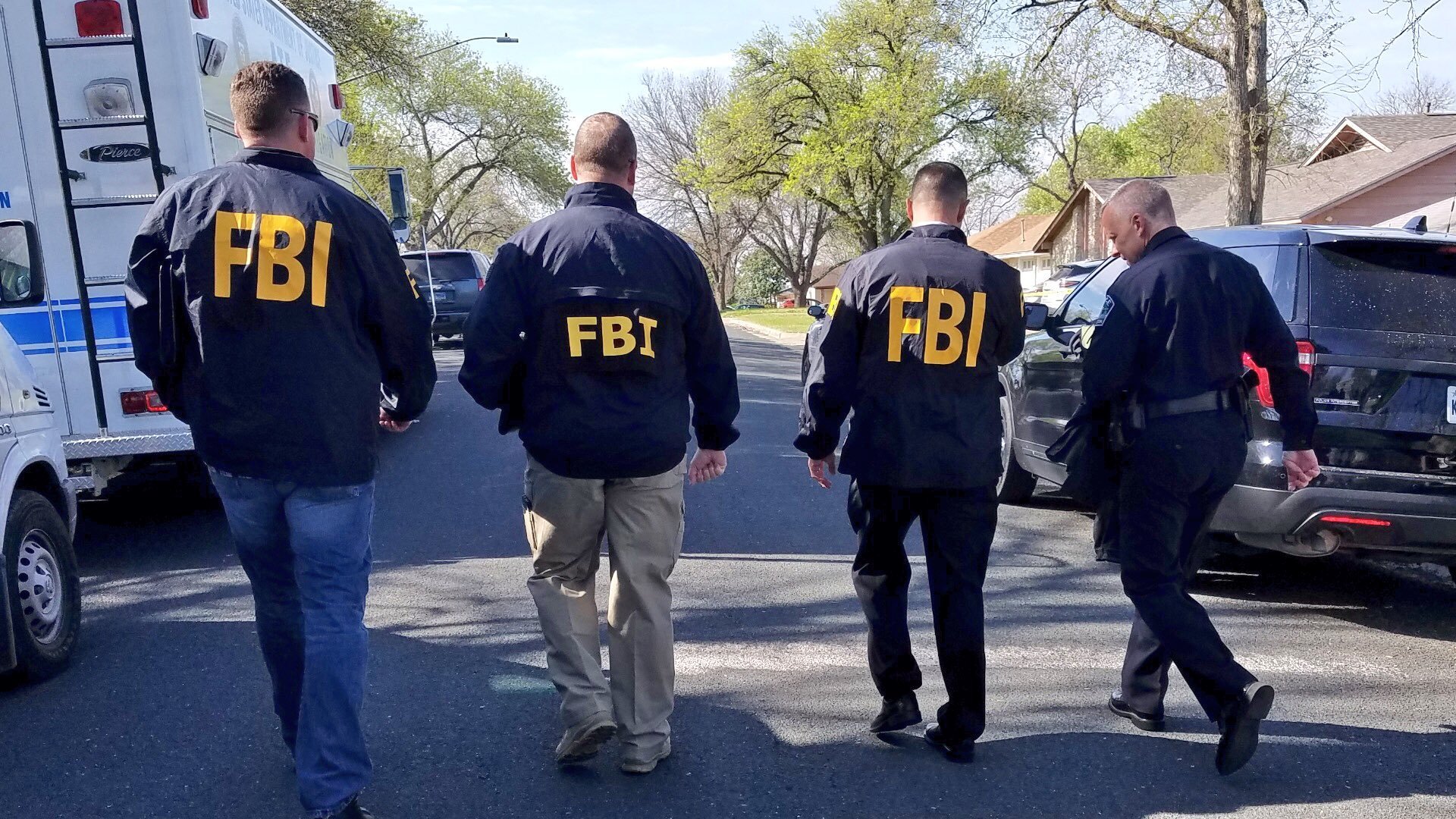 Law enforcement officials investigate on March 12, 2018, after a series of bombs were delivered to Austin homes, killing at least one. (Credit: Austin Police Department)