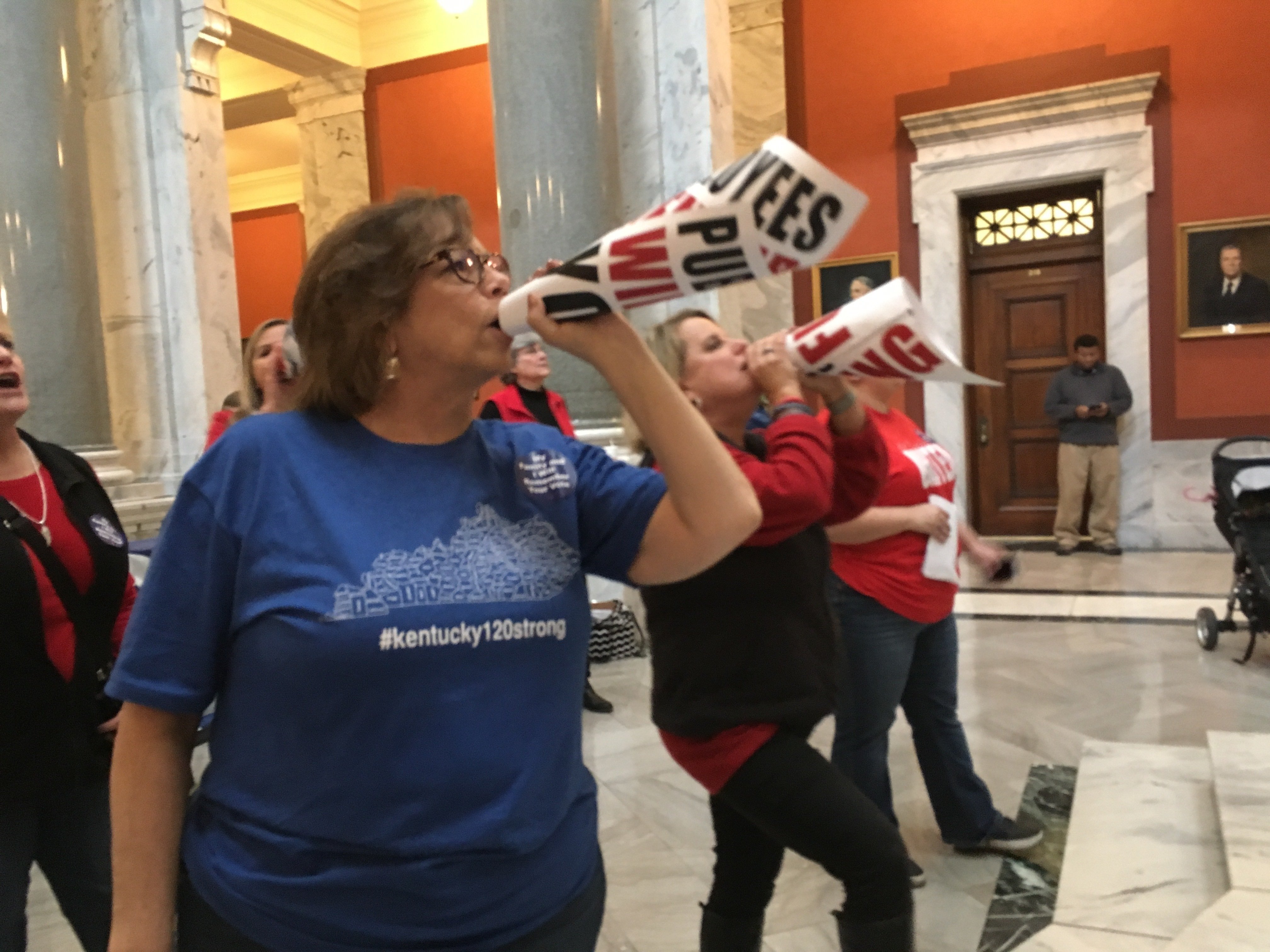 Retired teacher Lydia Coffey chants "Vote them out" as lawmakers in Kentucky debate a bill to make changes to the state's pension system. (Credit: AP via CNN)