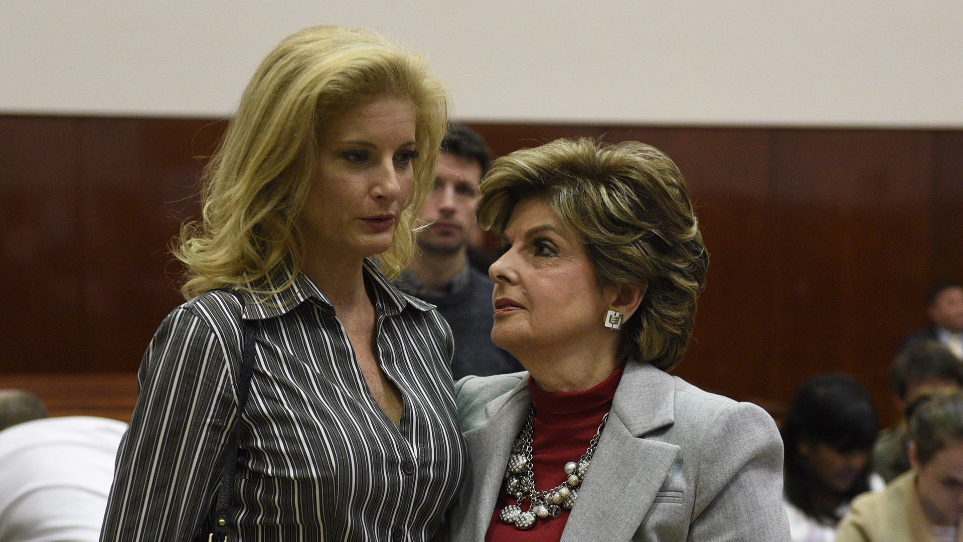 Summer Zervos, left, a former contestant on "The Apprentice," listens to her lawyer Gloria Allred in New York County Criminal Court on Dec. 5, 2017, in New York. (Credit: BARRY WILLIAMS/AFP/Getty Images)