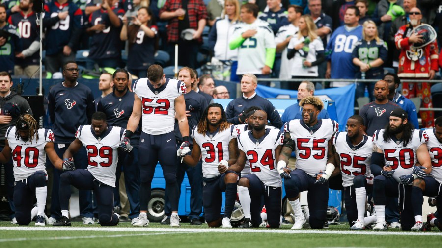 Members of the Houston Texans stand and kneel before the game against the Seattle Seahawks at CenturyLink Field on October 29, 2017 in Seattle. (Credit: Otto Greule Jr/Getty Images)