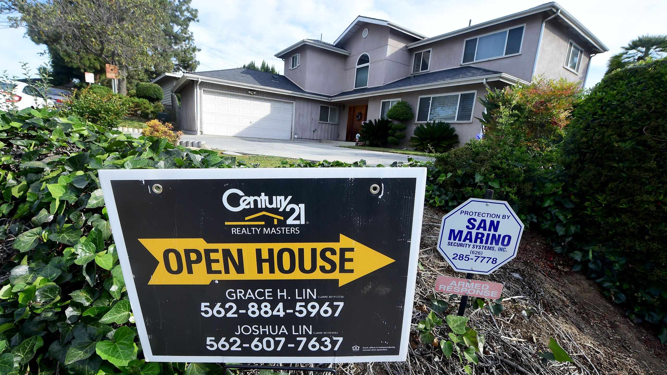 An open house sign directs prospective buyers to property for sale in Monterey Park on April 19, 2016. (Credit: Frederic J. Brown / AFP / Getty Images)