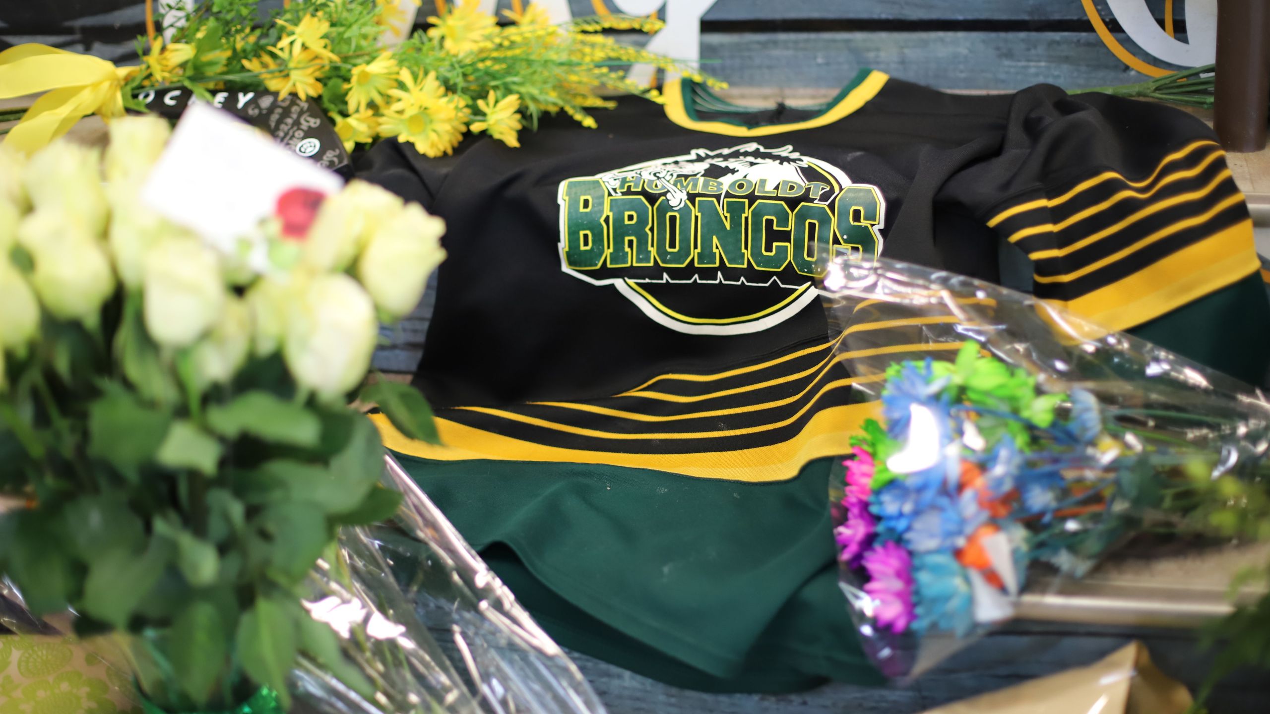 An ice hockey jersey is left in a makeshift memorial at the Humboldt Uniplex in Humboldt, Canada, on April 8, 2018. (Credit: KYMBER RAE/AFP/Getty Images)