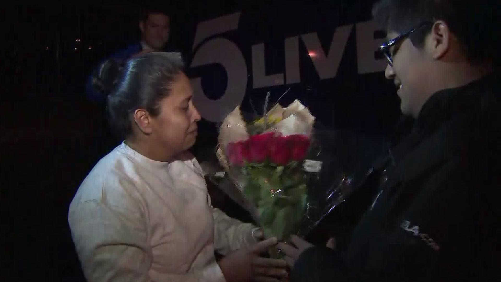 Marcelina Rios is tearful as her son Roberto hands her a bouquet of flowers upon her release from immigration detention in Adelanto on April 12, 2018. (Credit: KTLA)