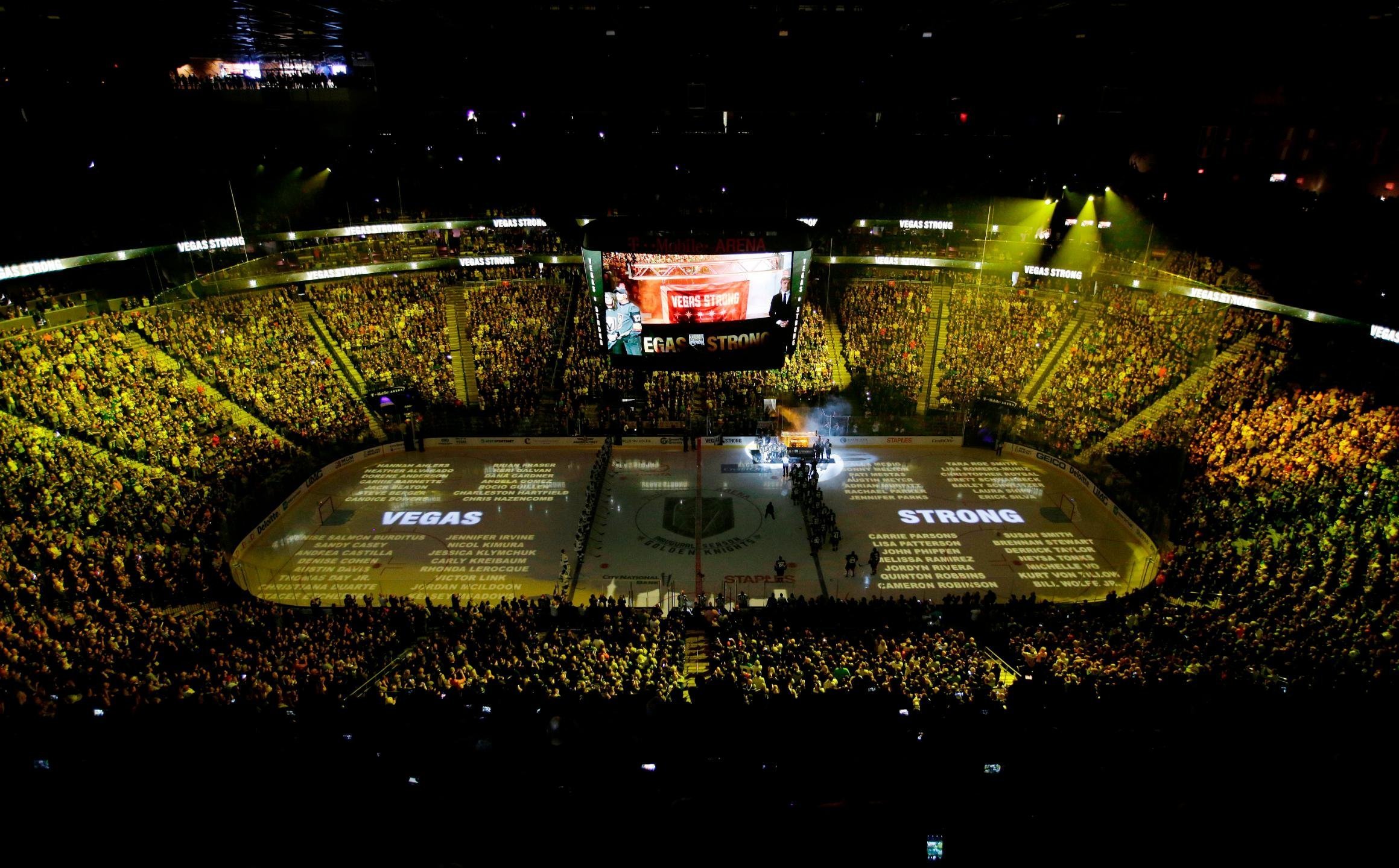 The names of people killed during the mass shooting in Las Vegas last year are projected on the ice during a ceremony before an NHL hockey game between the Vegas Golden Knights and the San Jose Sharks on Saturday in Las Vegas. (Credit: John Loocher/AP)